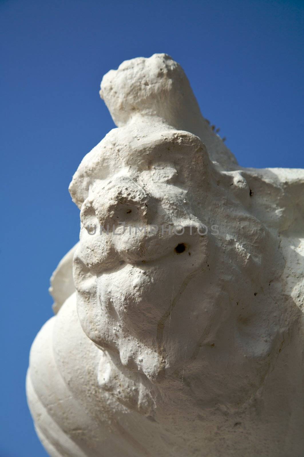 detail of flowerpot with sculpture face of a devil