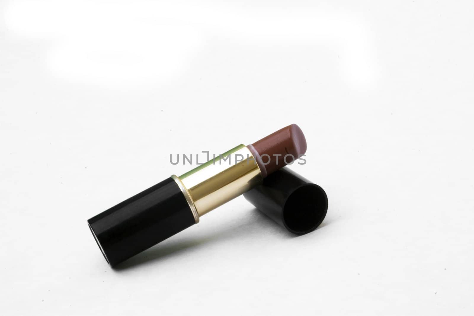 Maroon lipstick with lid off isolated against white background