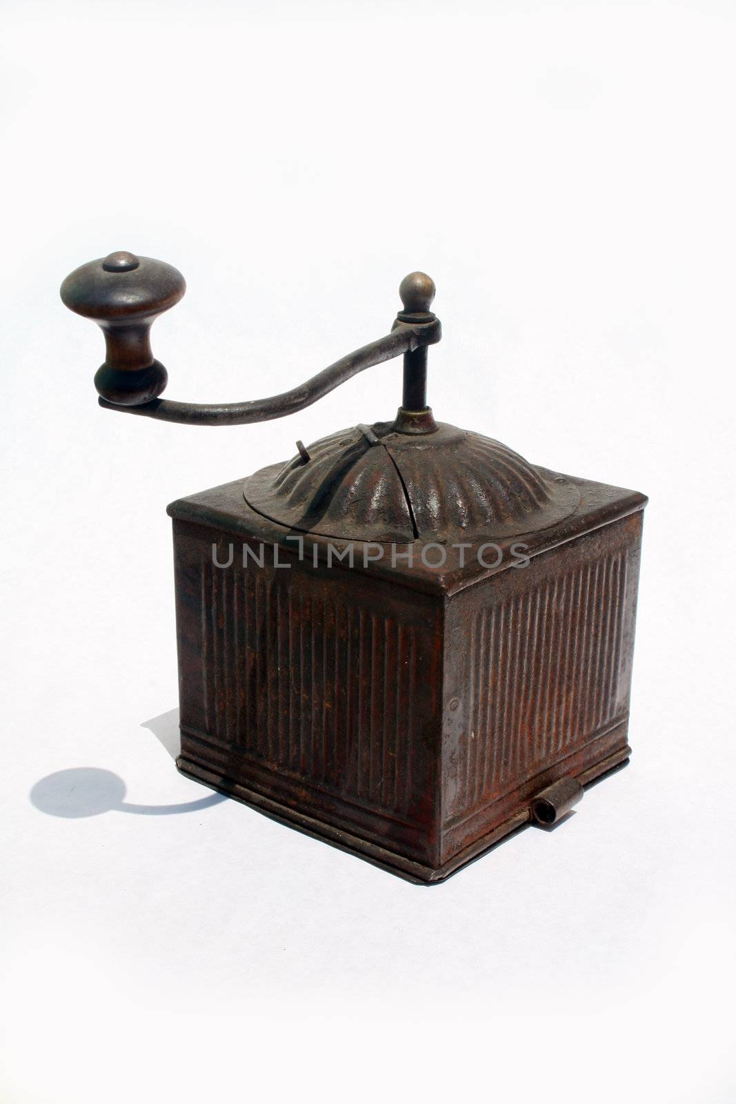 Antique spice grinder against white background