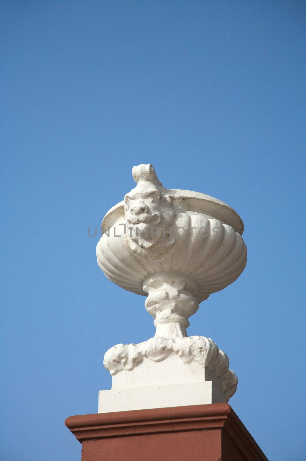 white flowerpot with a sculpture face at icod city tenerife spain