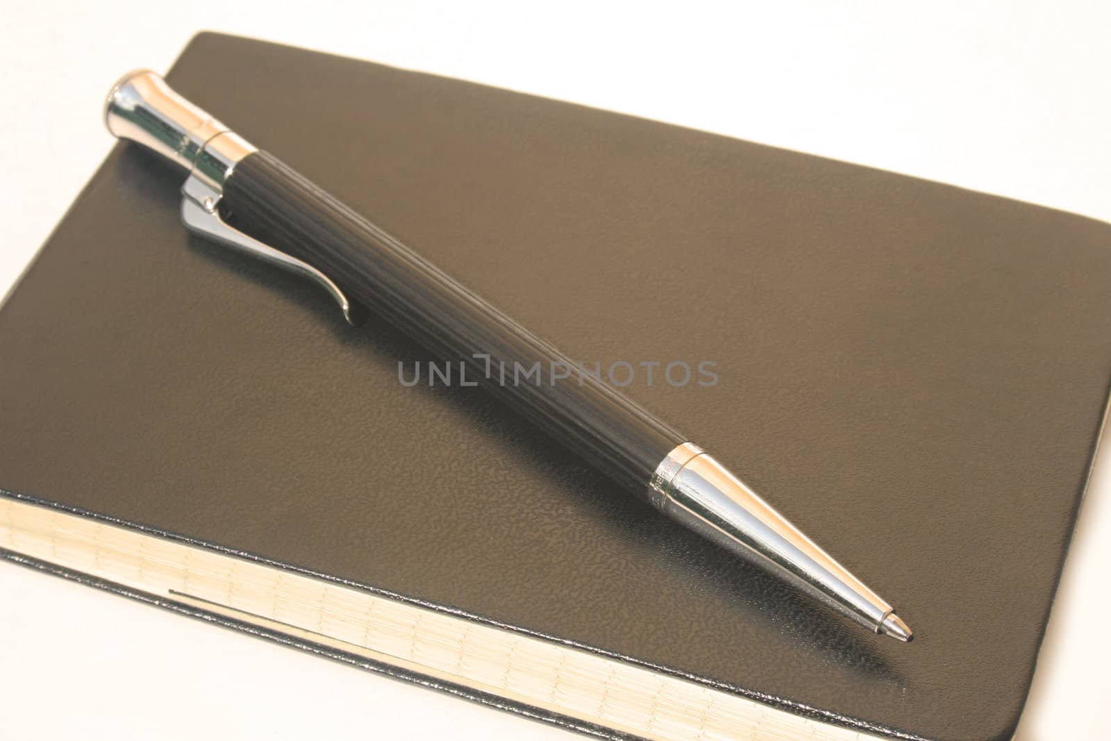 Ballpoint pen on rectangular leather notepad