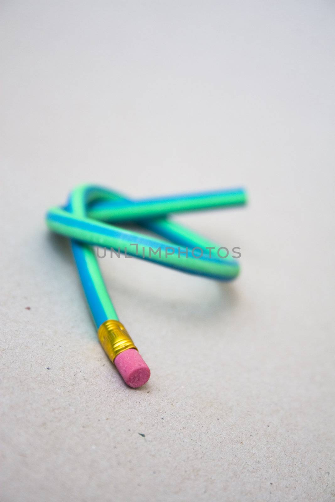 Green rubber pencil twisted into a knot by timscottrom