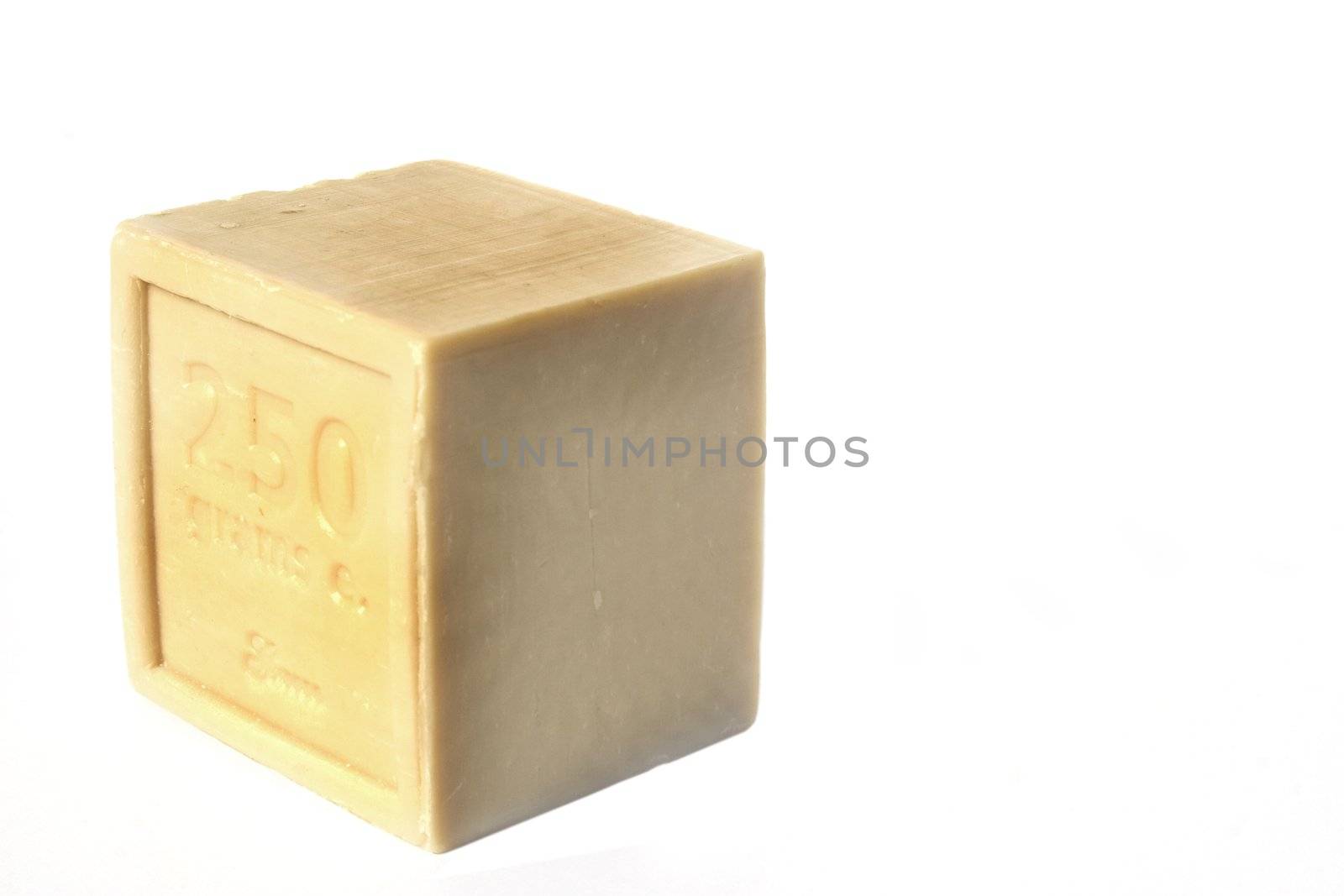 Square block of natural soap isolated against white background