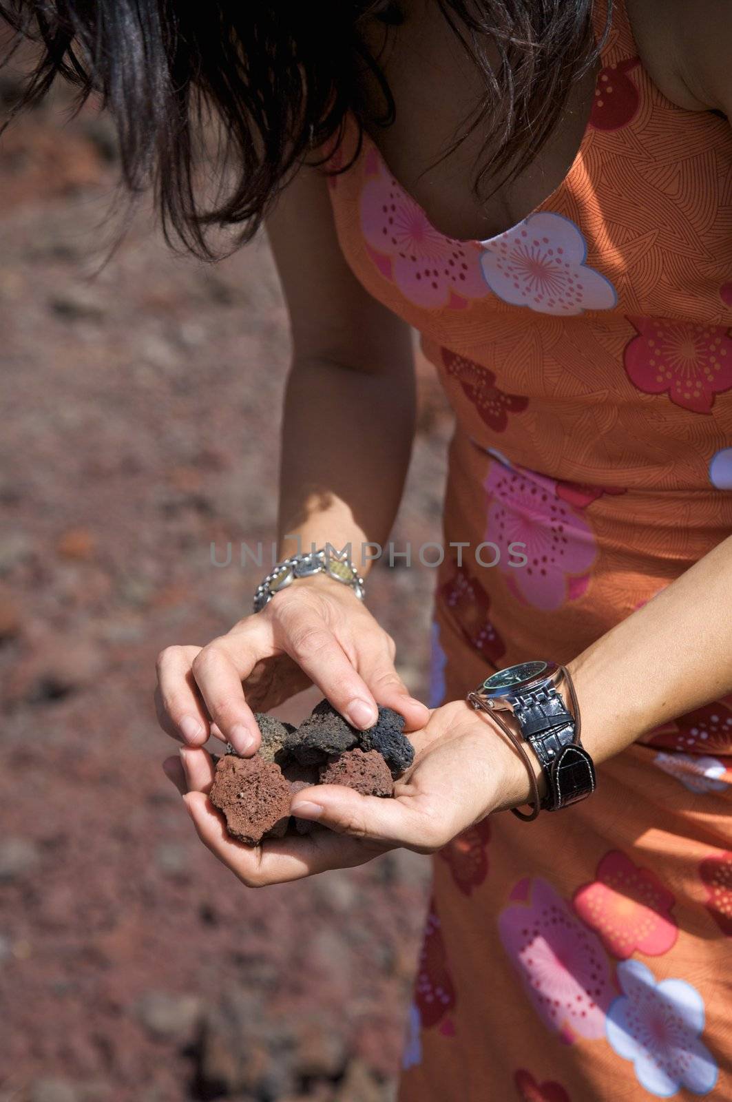 woman with volcanic stones on her hands