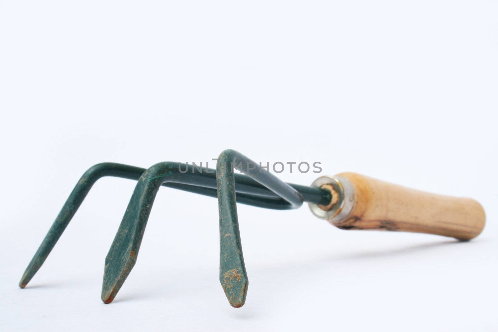 Hand rake for gardening against white background