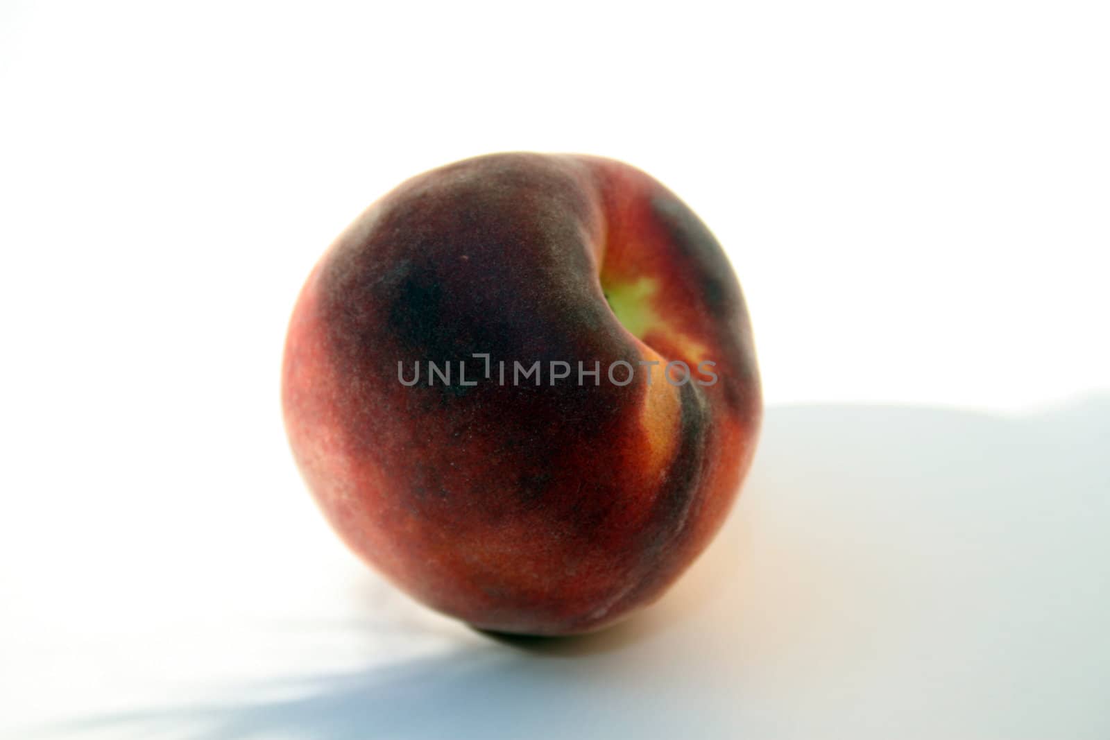 Peach on white background and shadow