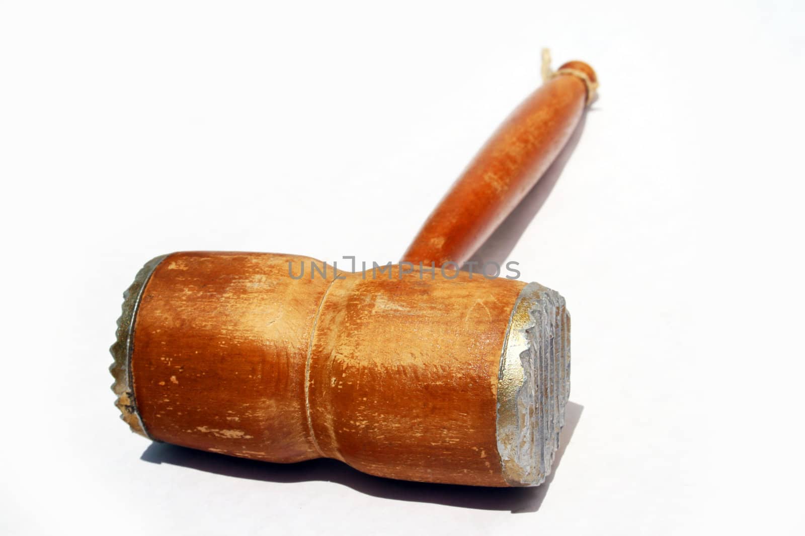Wooden antique meat tenderizing hammer against white background