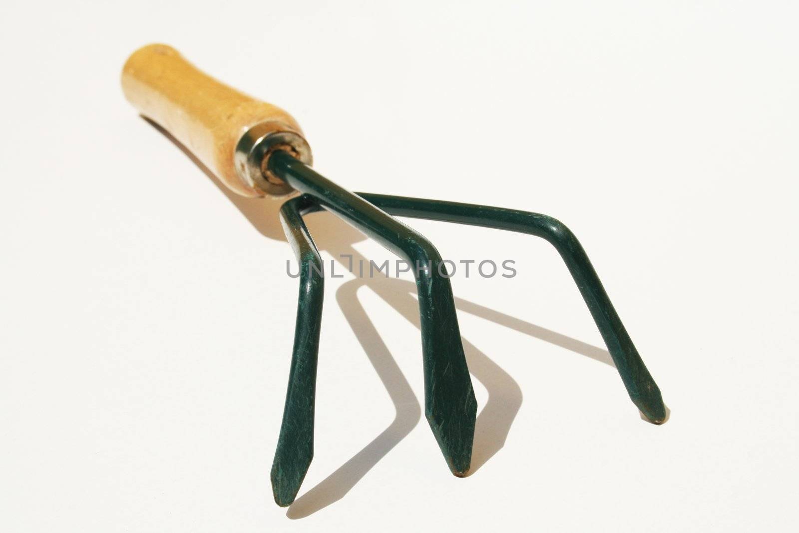 Hand cultivator fork tool against white background