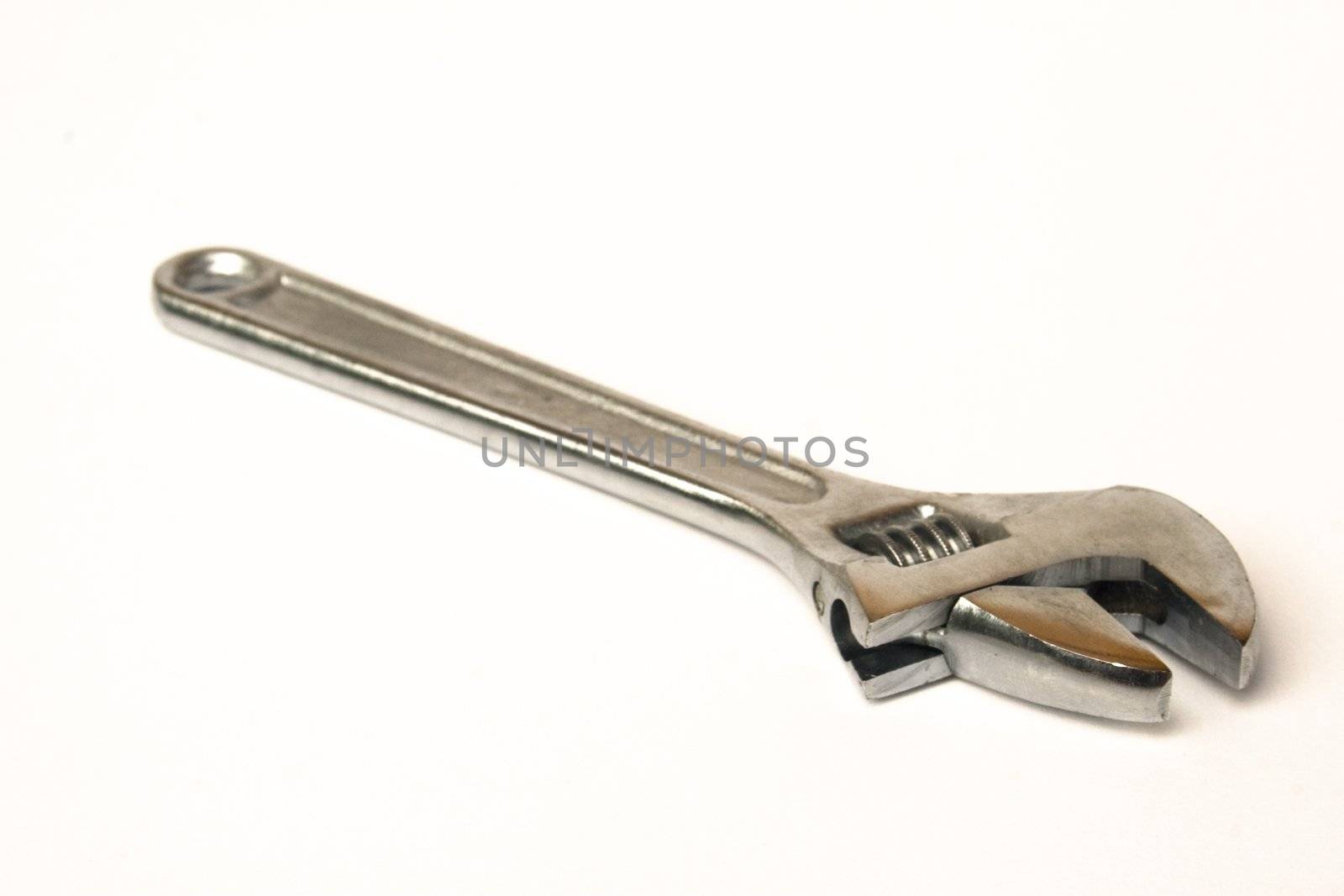 Standard chromed crescent wrench isolated against white background