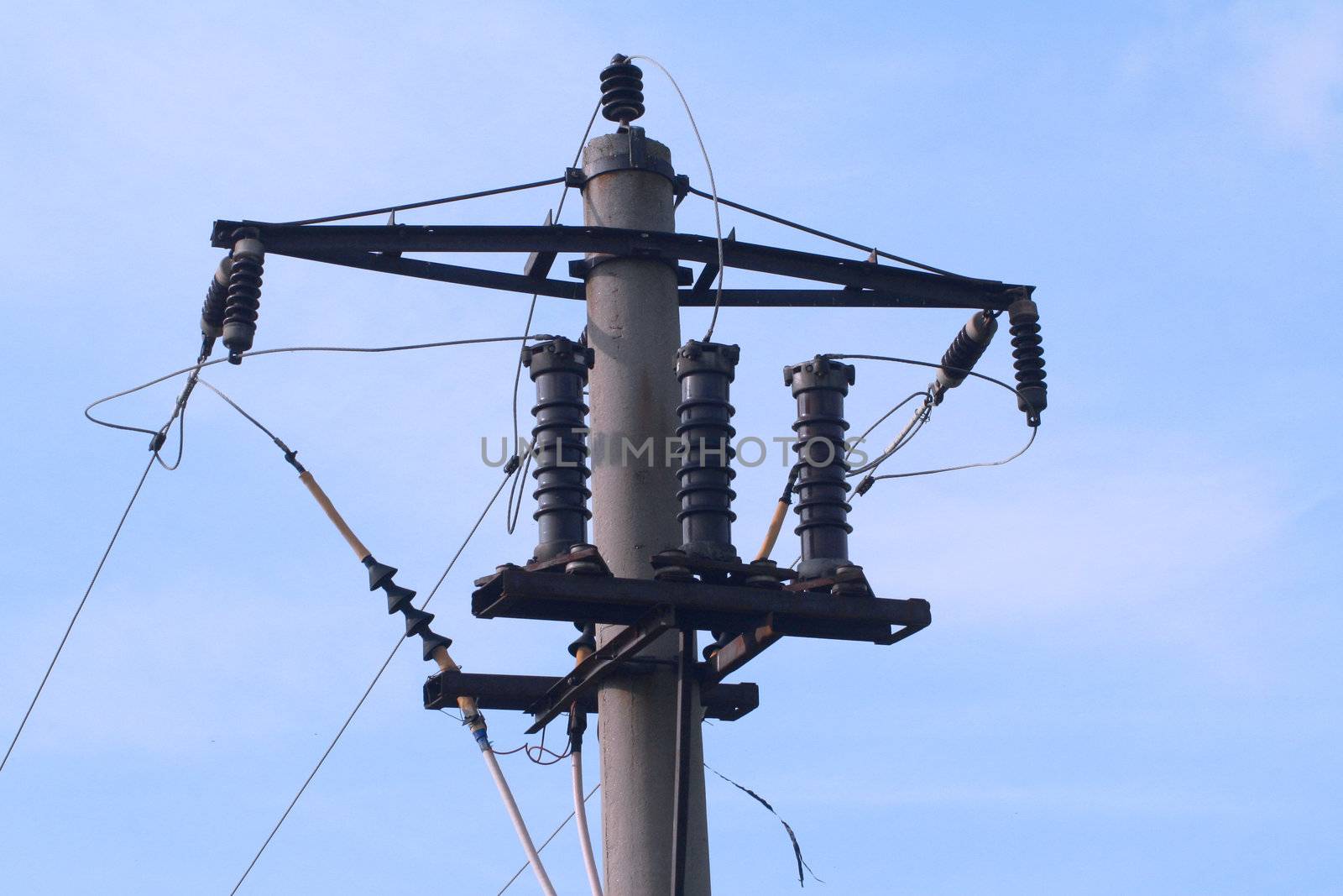 Electrical utility pole against blue sky