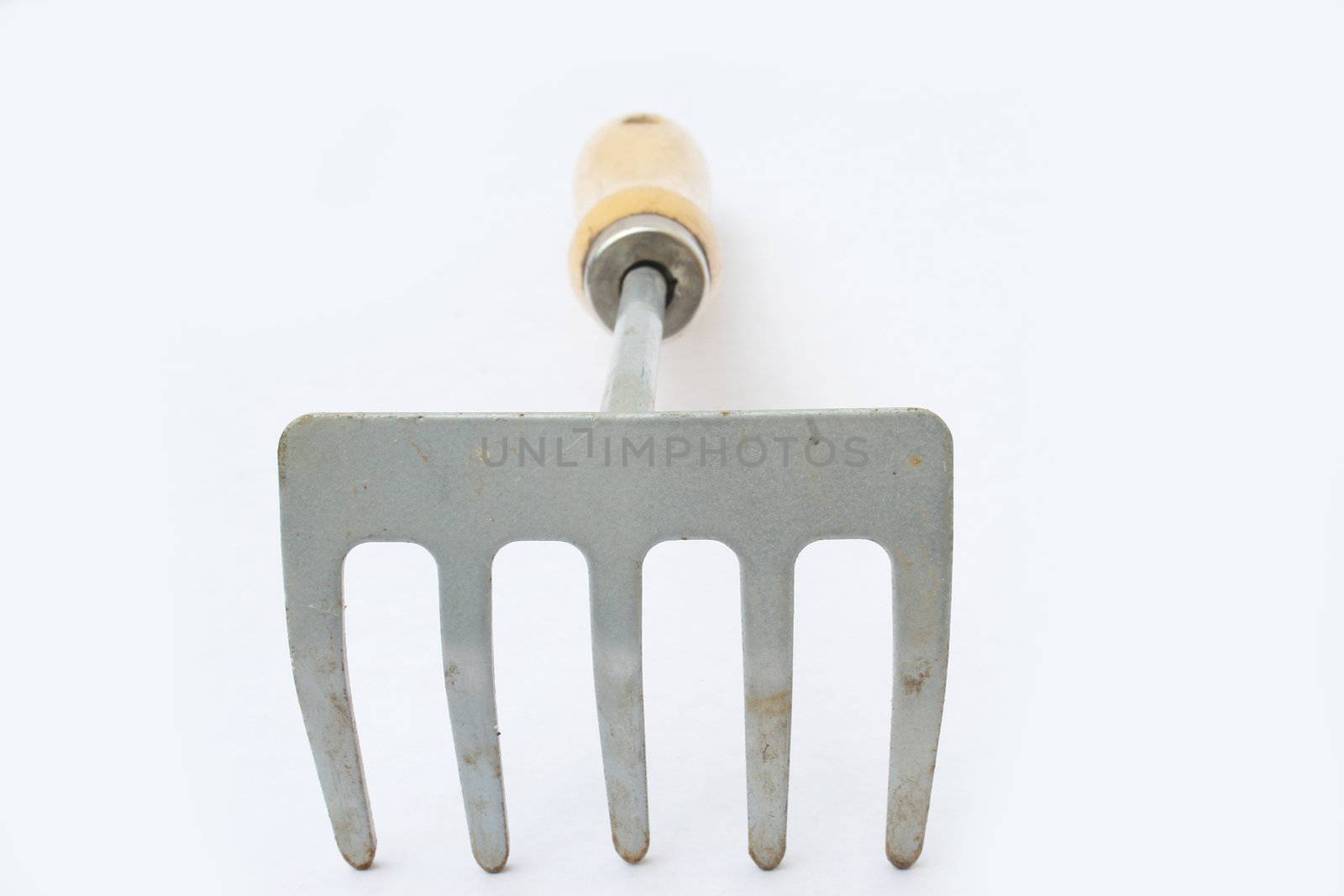 Hand rake from front with shallow depth-of-field against white background