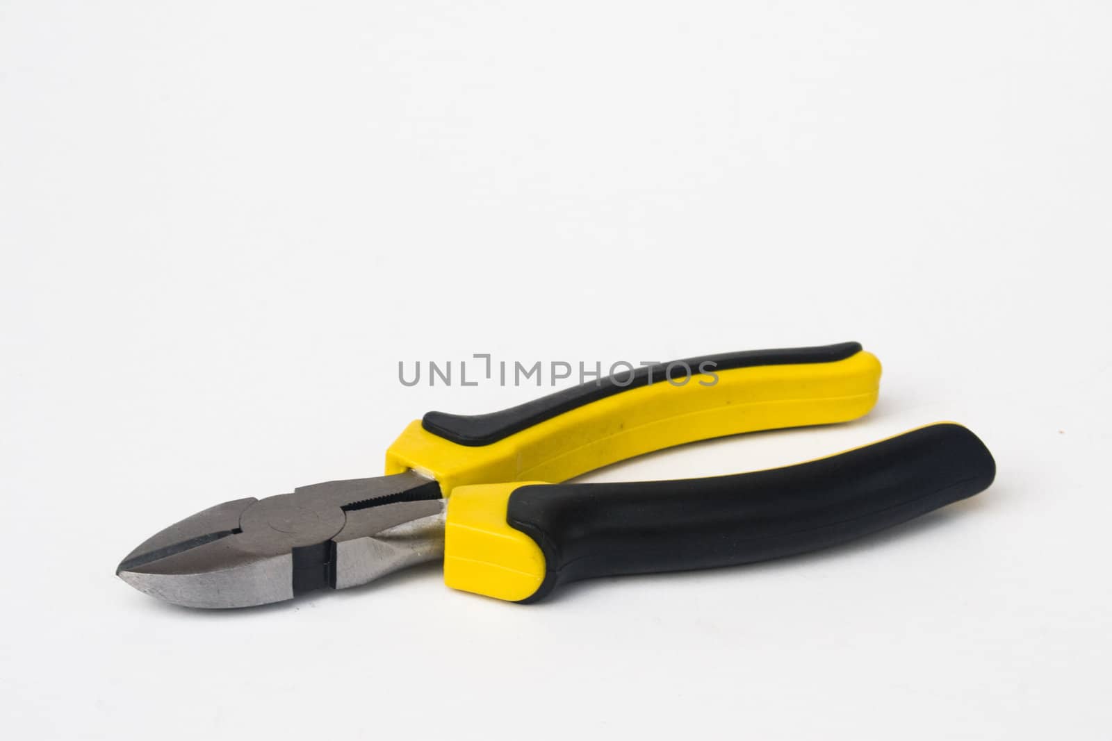 Wire cutter with yellow and black handle against white background