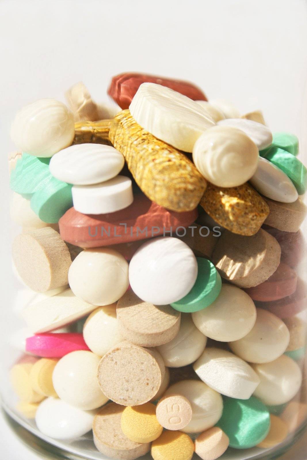 Bottle of various pills close-up