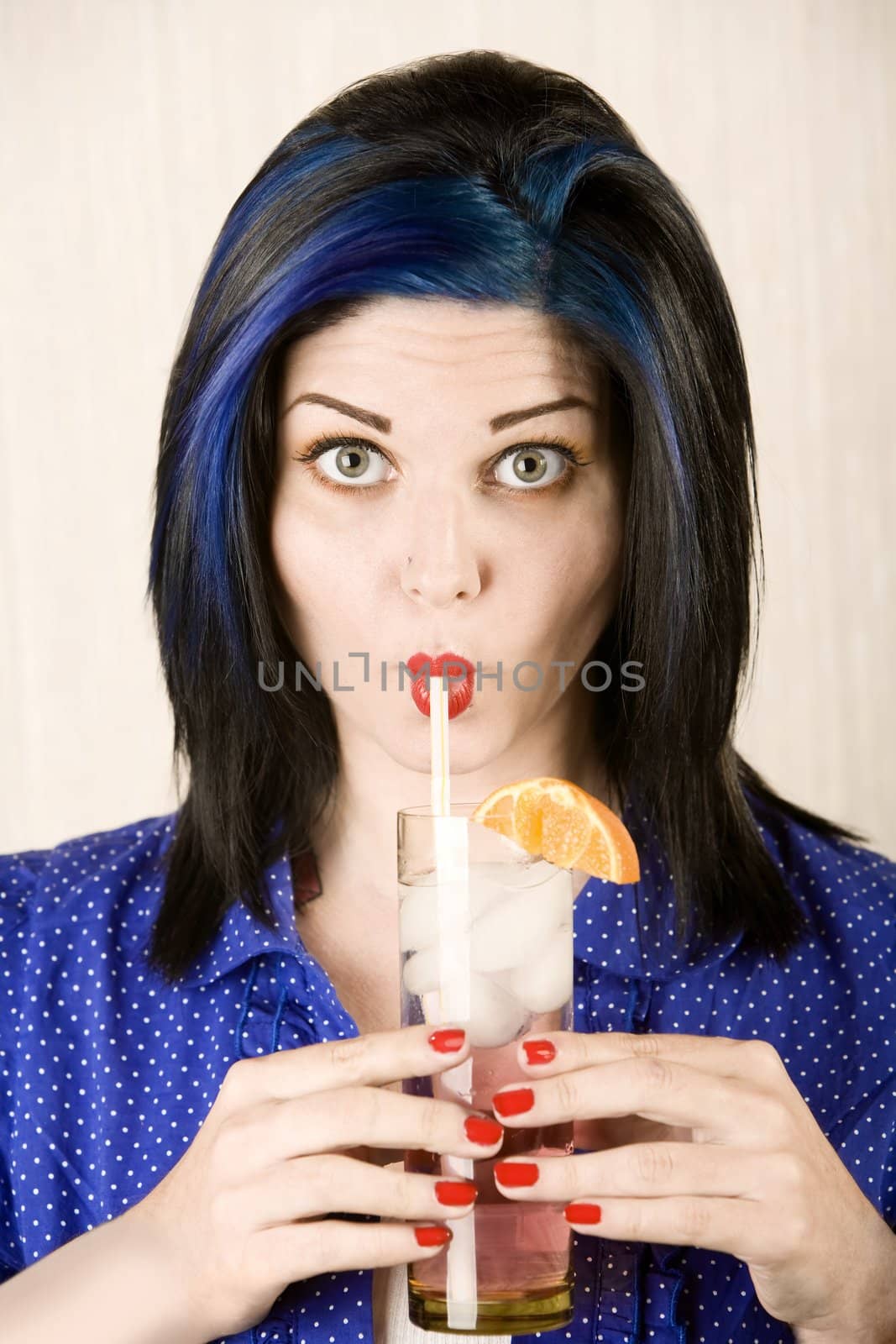 Pretty woman sipping cocktail through a straw