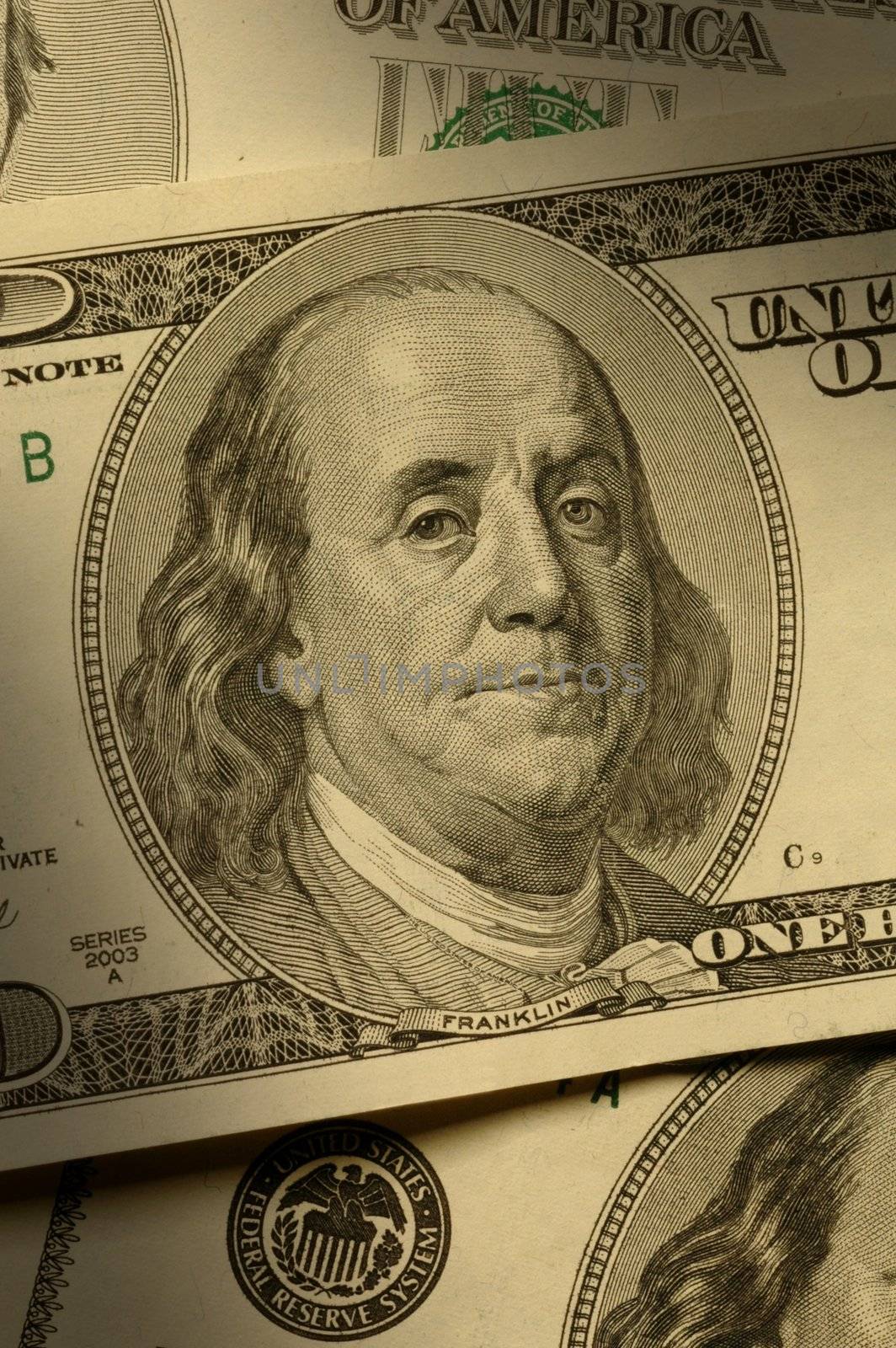 Close-up of Benjamin Franklin on the $100 bill, dramatically lit.