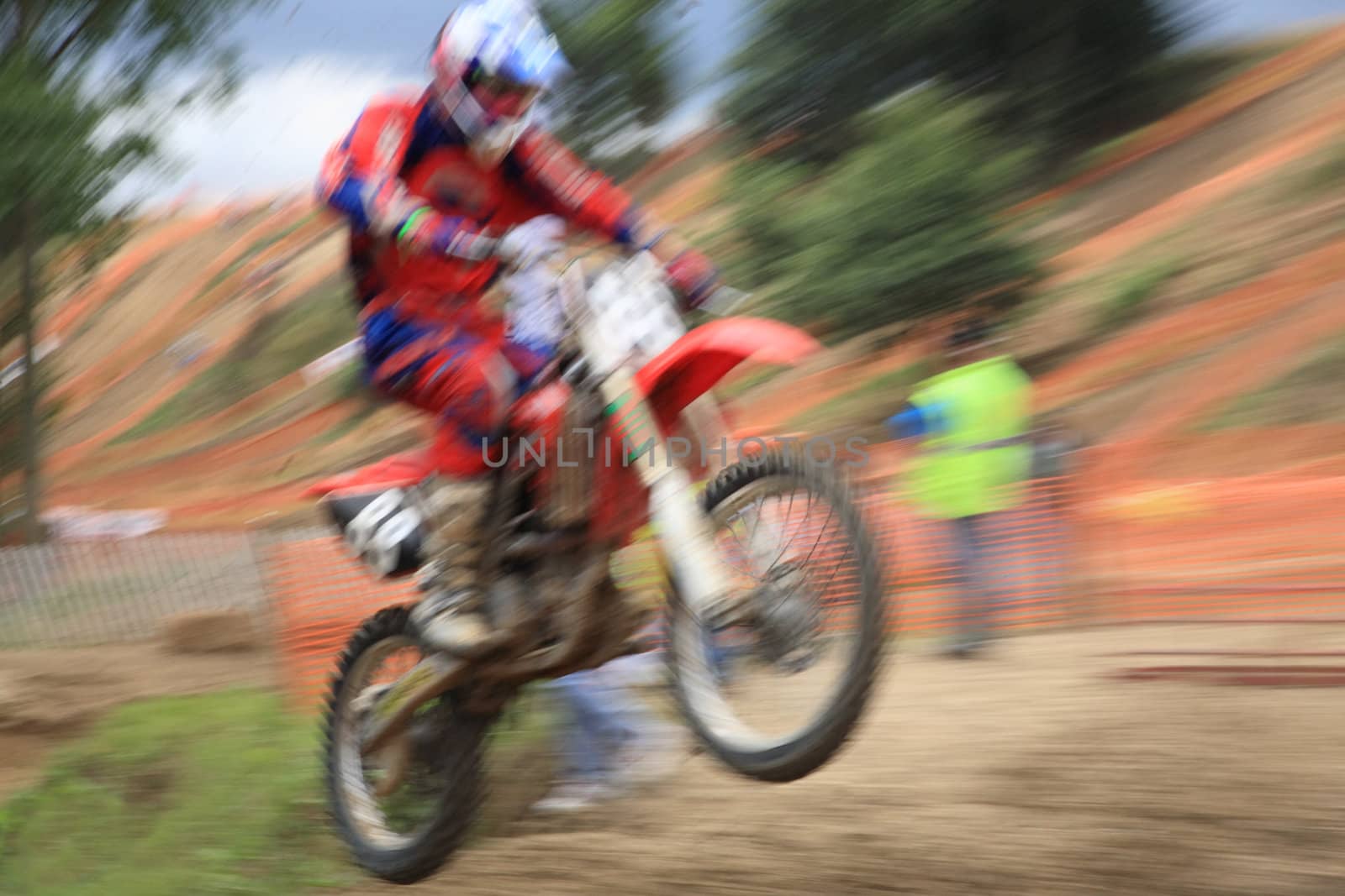 Motocross rider, abstract image created with intentional motion blur and zooming effect.