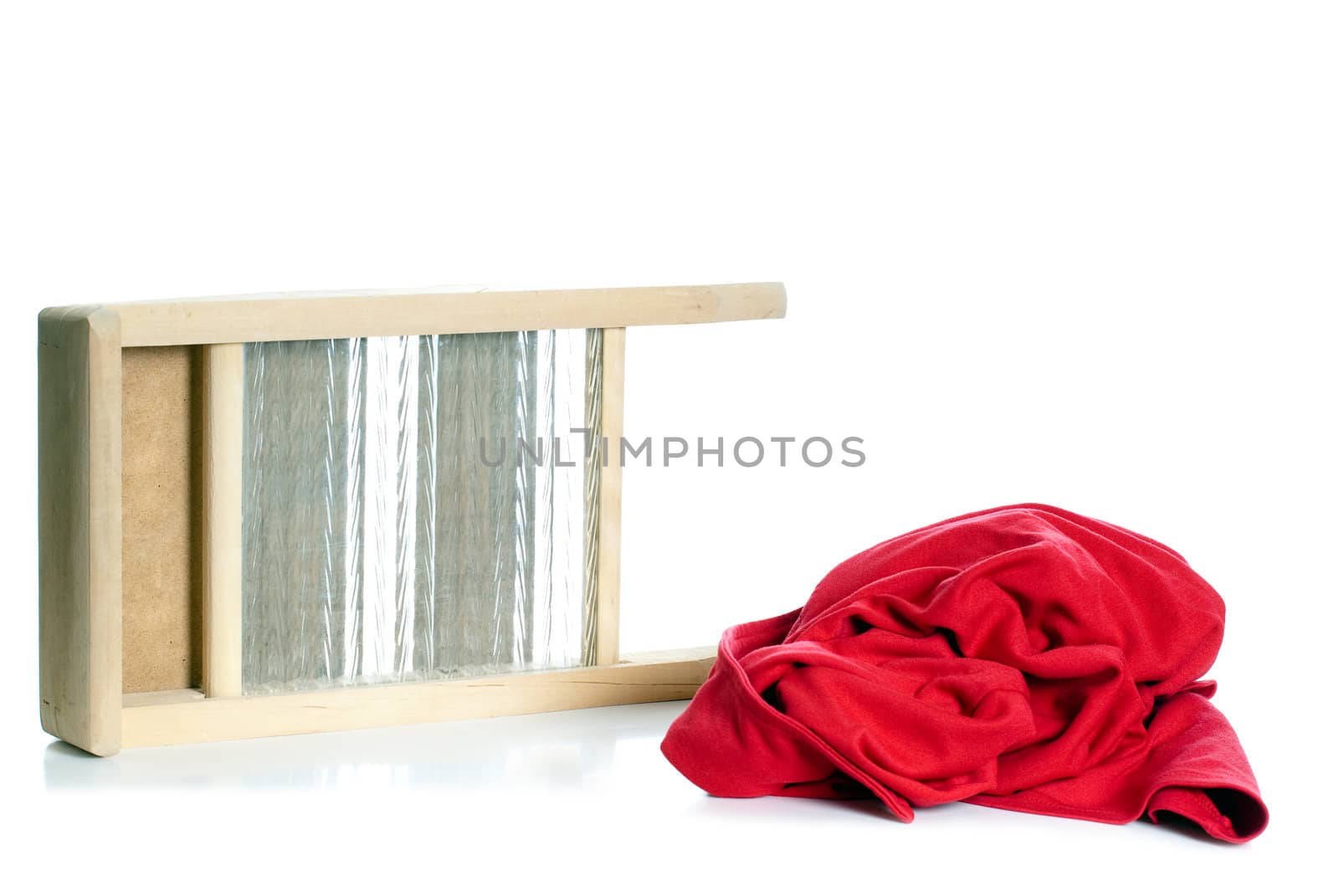 A washboard and a red sweater representing an old fashioned cleaning concept, isolated against a white background