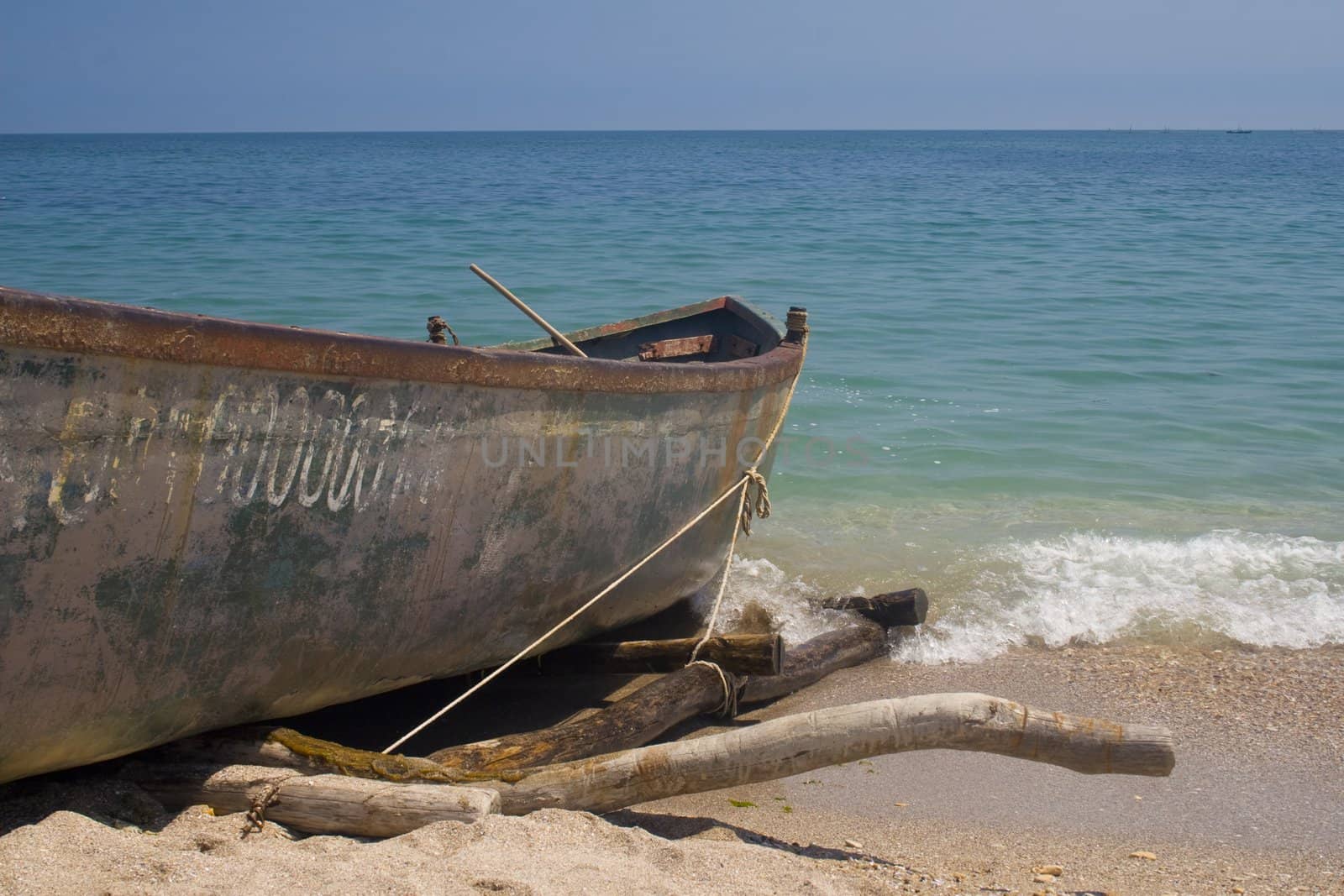 Fishing boat on beach by timscottrom