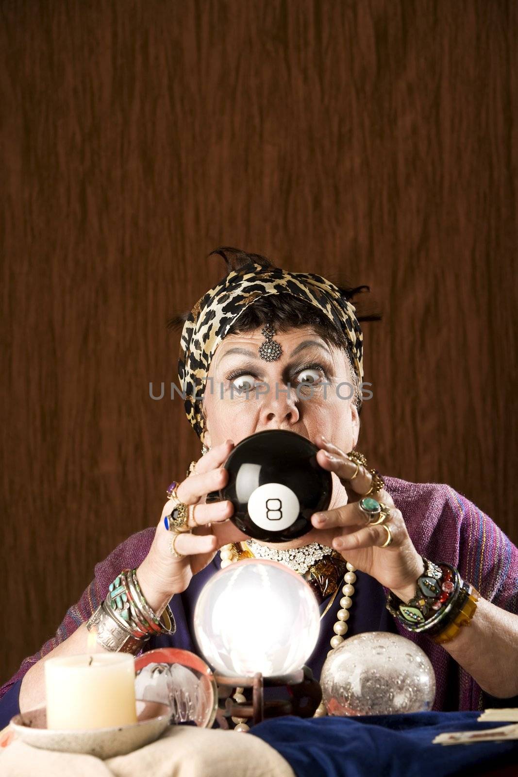 Gypsy looking at an eight ball to predict the future