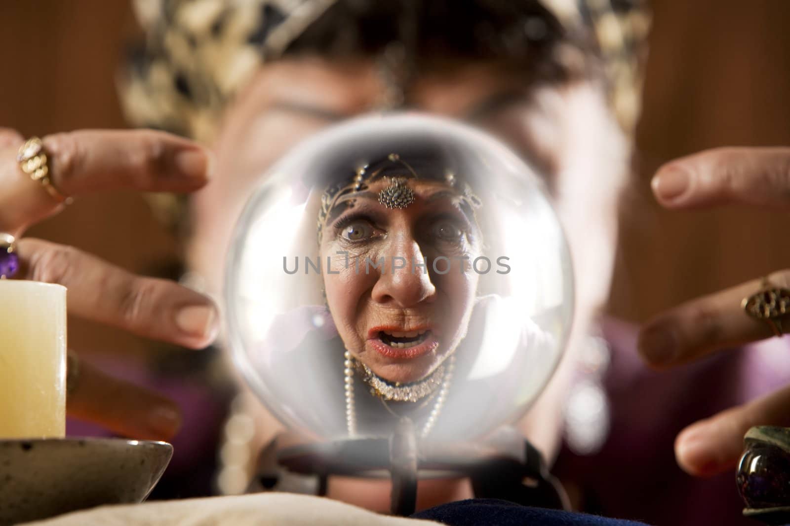 Female gypsy fortune teller looking into a crystal ball