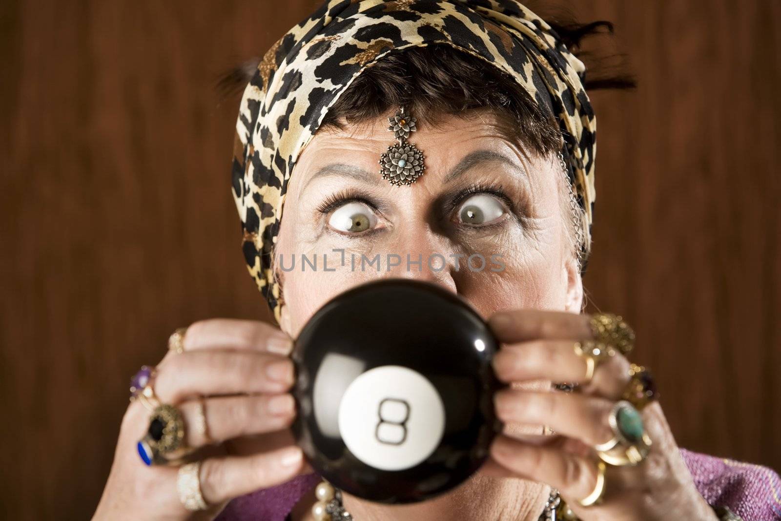 Gypsy looking at an eight ball to predict the future