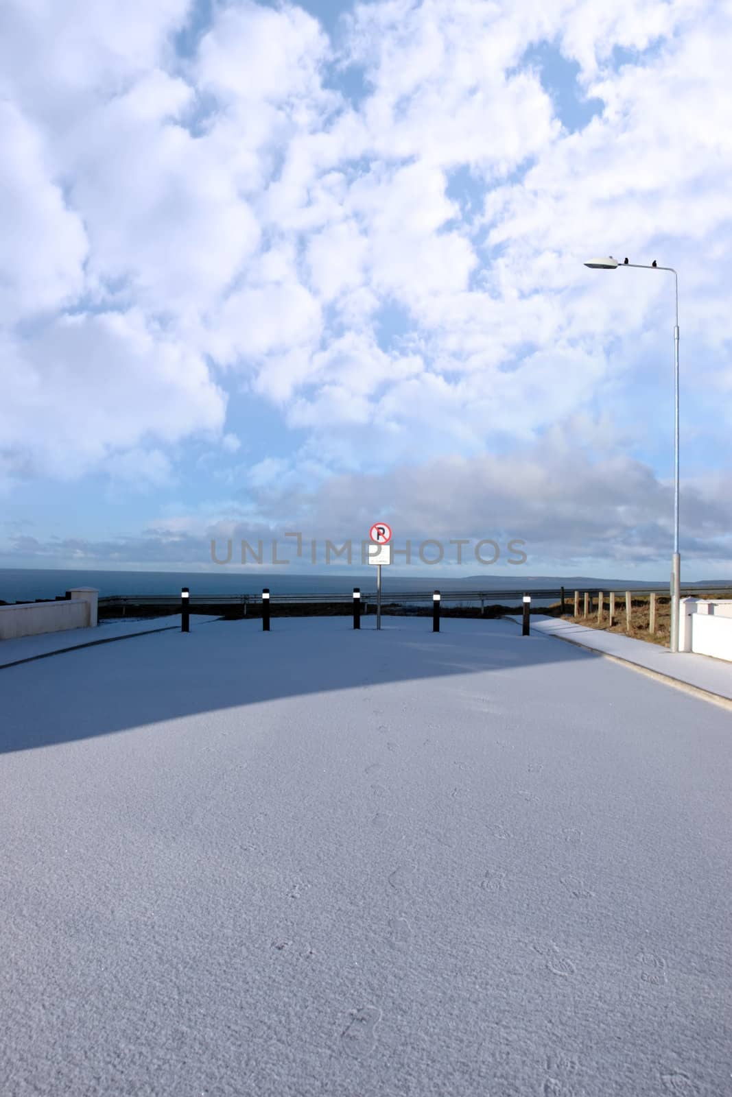 a snowy covered coastal culdesac road in ballybunion ireland
