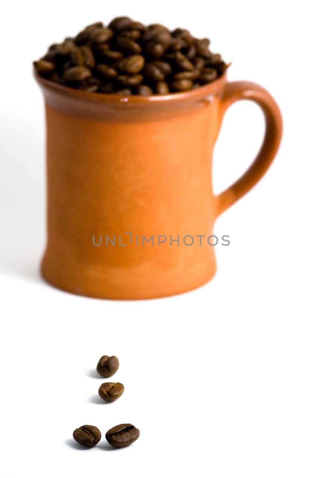 Roasted coffee and cup, white background.