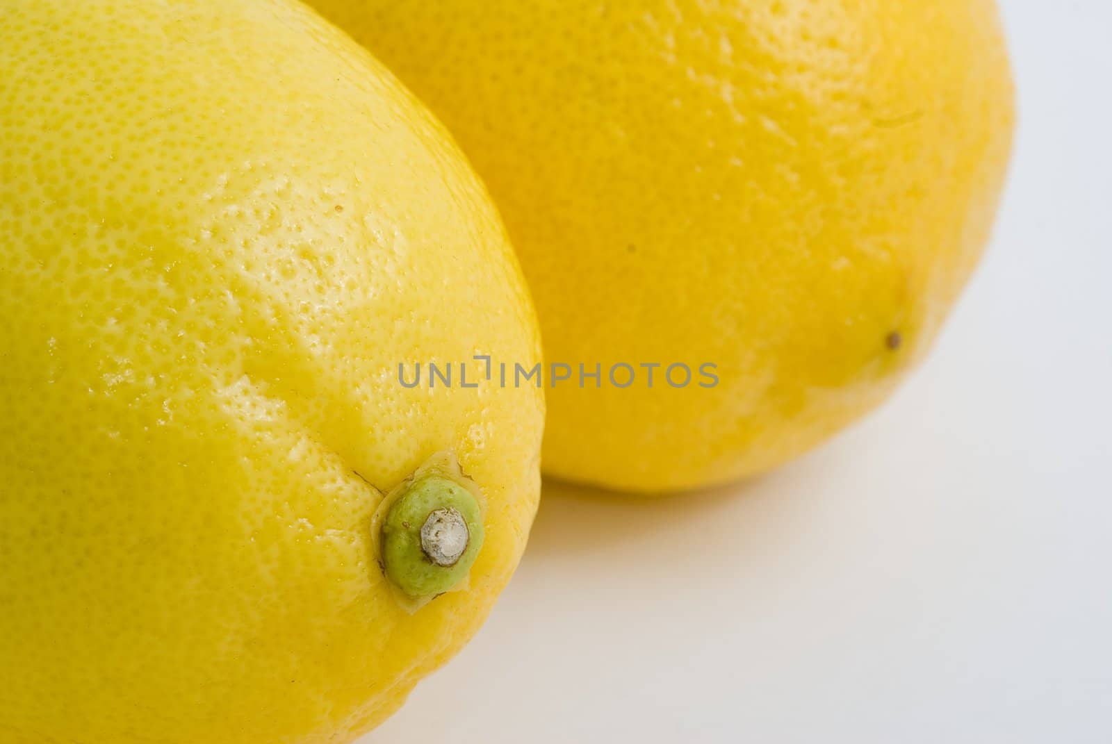 Fresh yellow lemons, white background