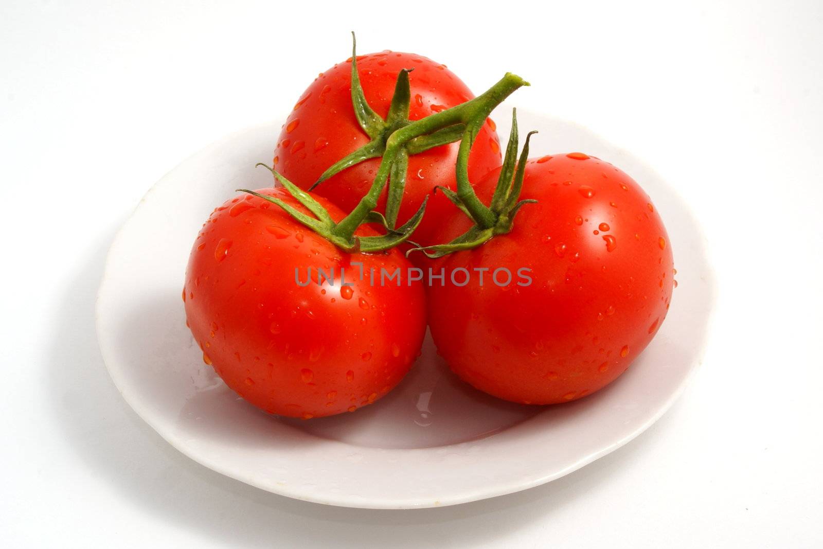 Fresh tomatoes on white background