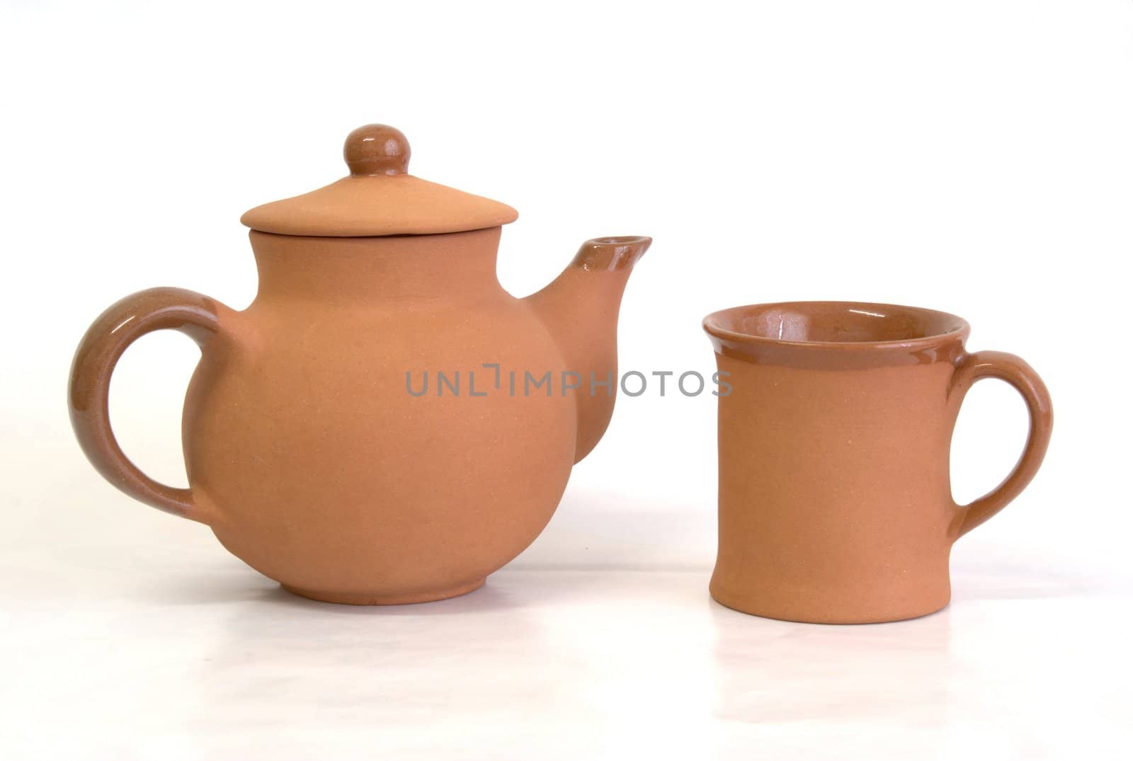 Teapot and cup on white background