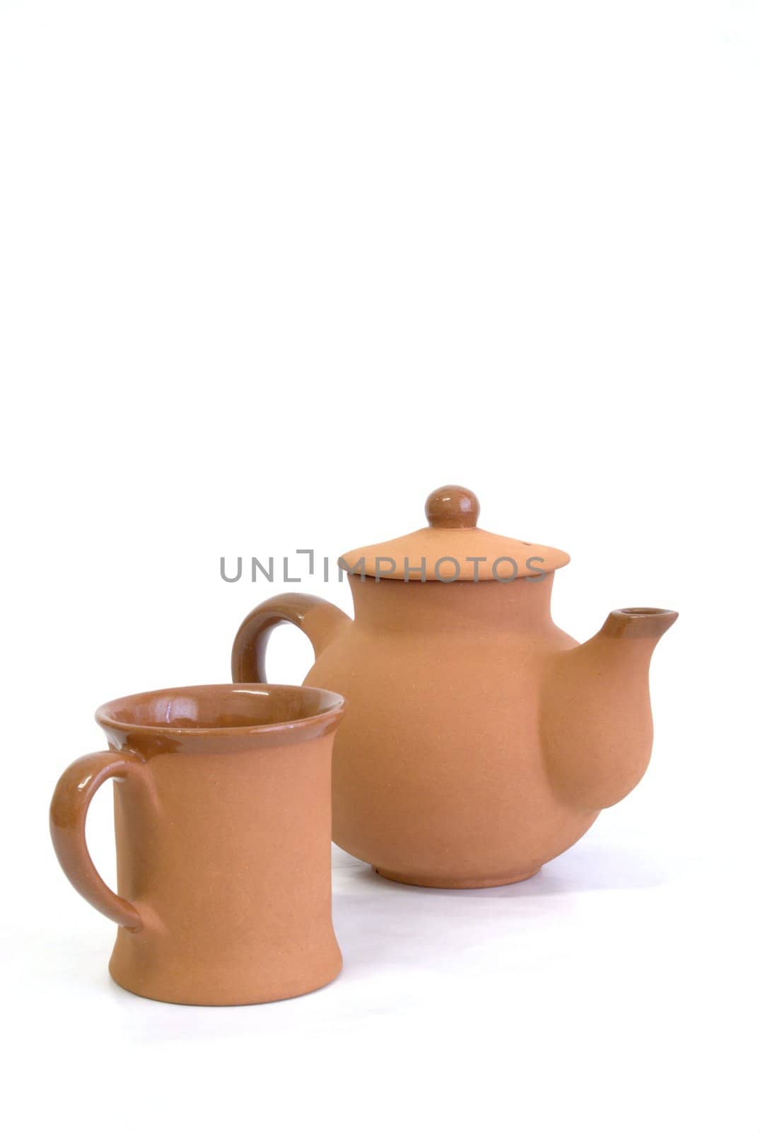 Teapot and cup on white background