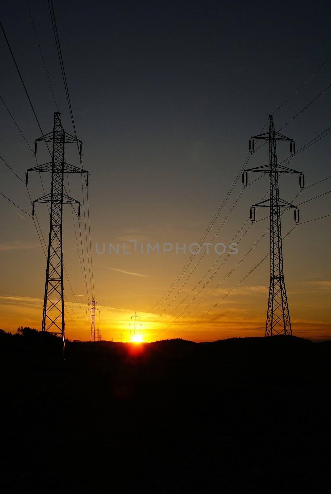 High voltage electricity pylon over sunset by pmisak