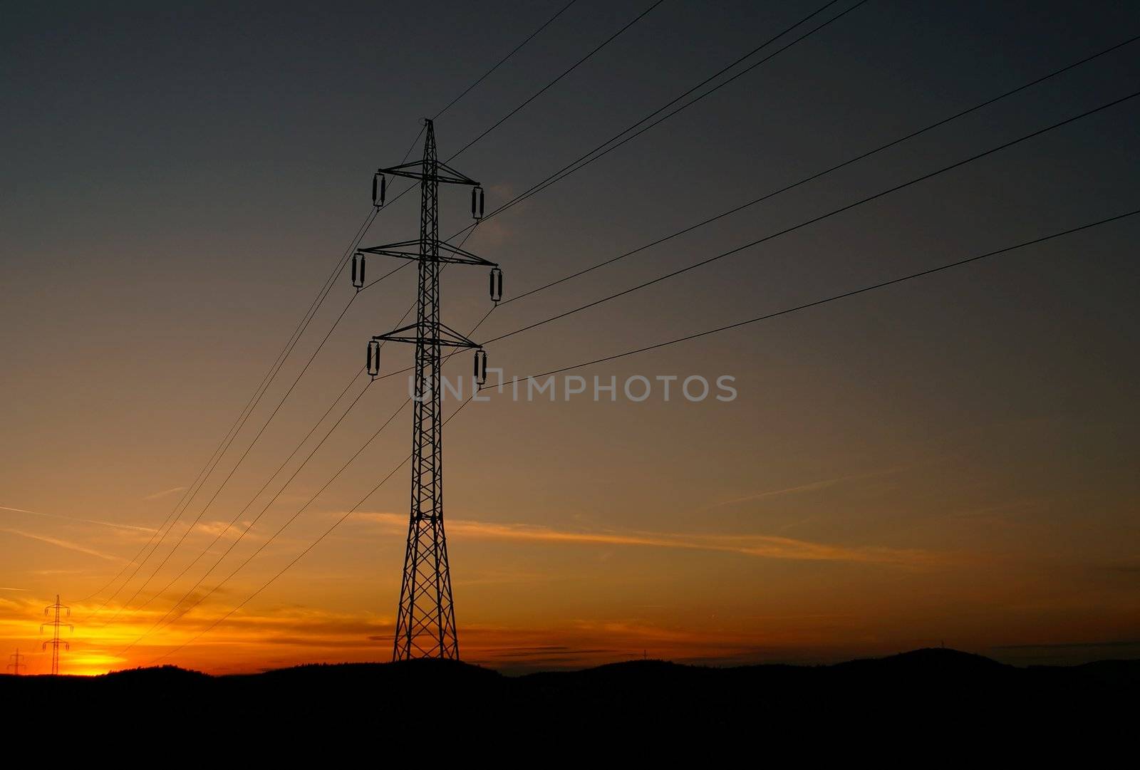 High voltage electricity pylon over sunset by pmisak