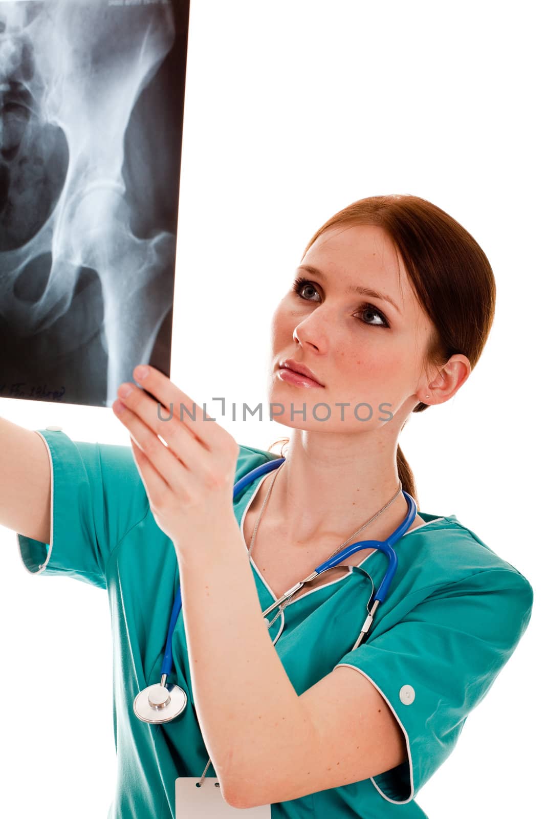 Pretty female doctor looking at the xray picture