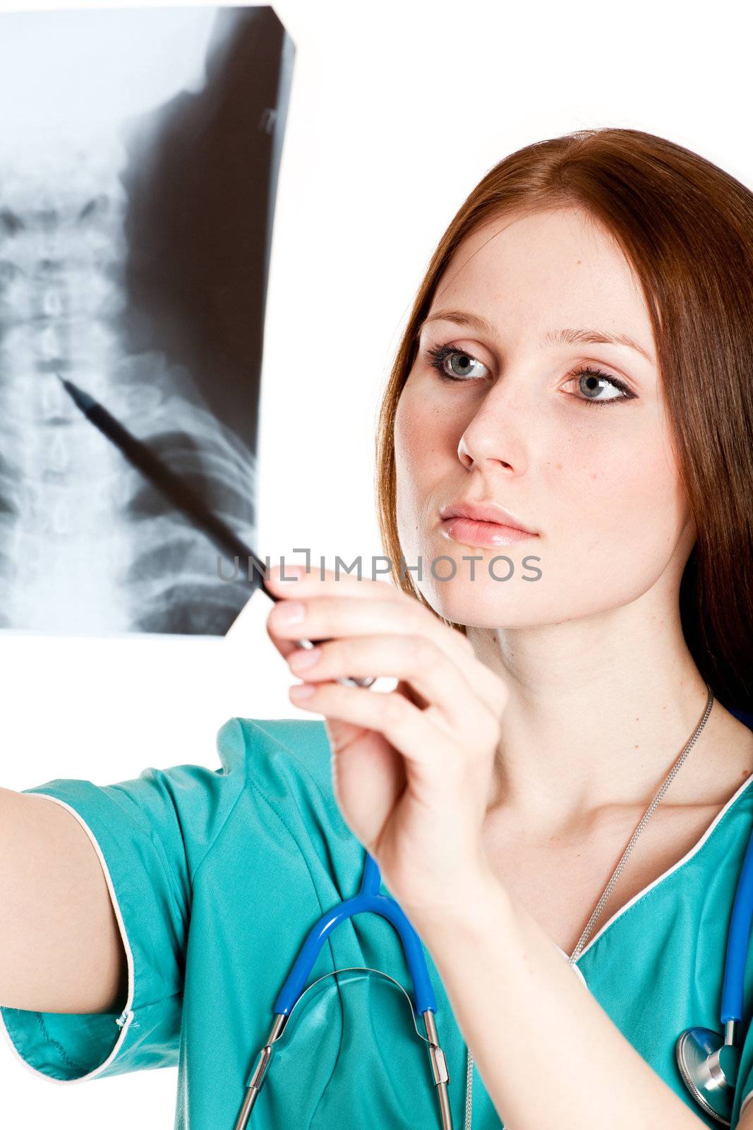 Pretty female doctor looking at xray picture