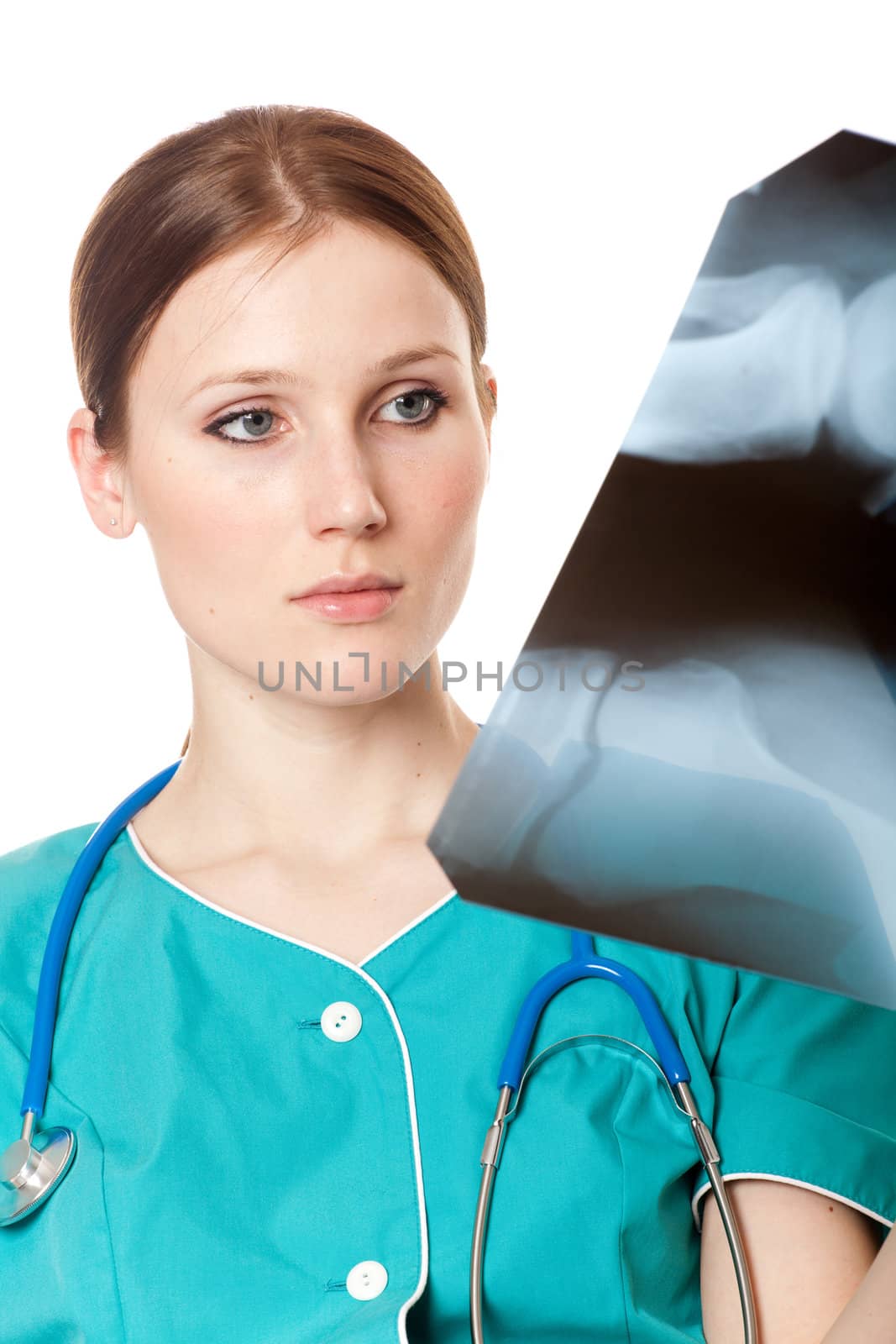 Pretty female doctor looking at the xray picture