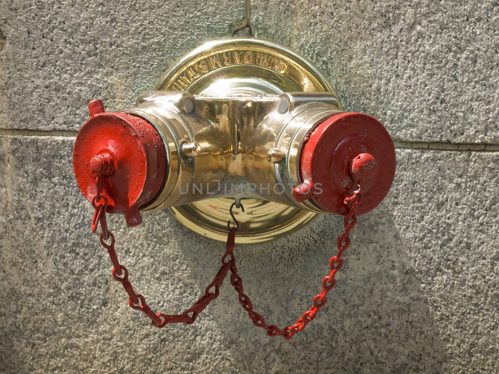 A standpipe on a New York City wall.