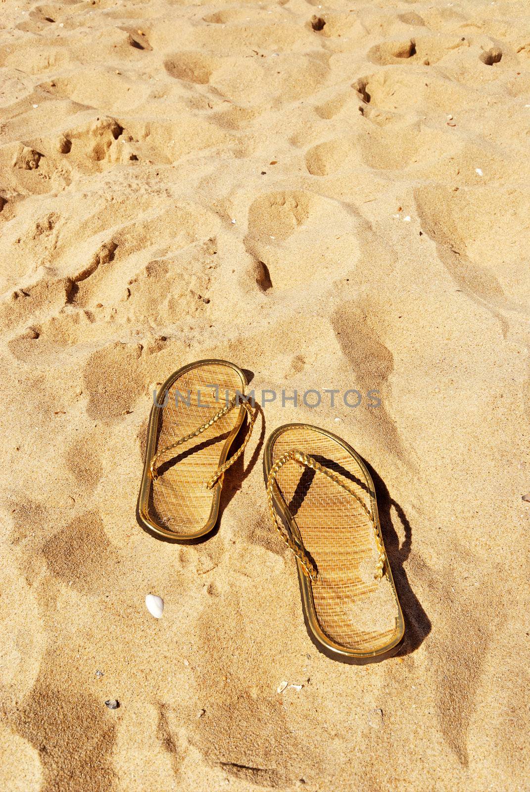 slippers on the beach by weknow