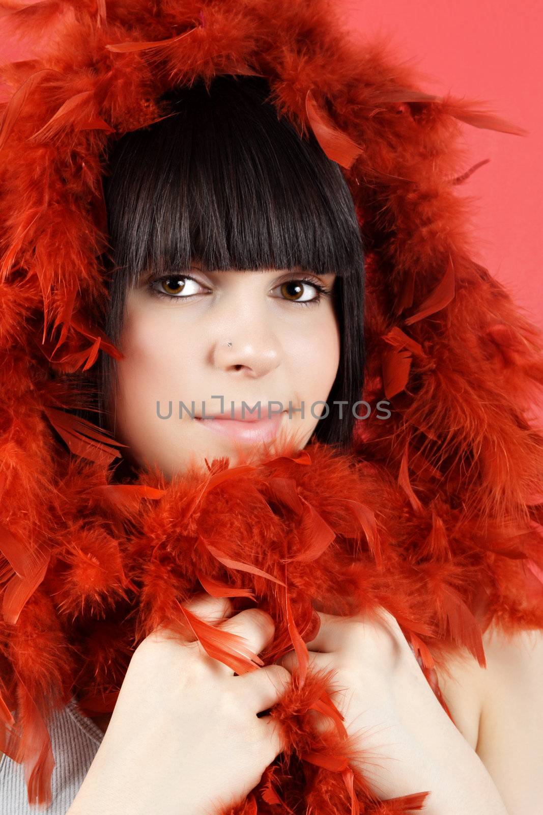 portrait of pretty teen girl with red feather boa