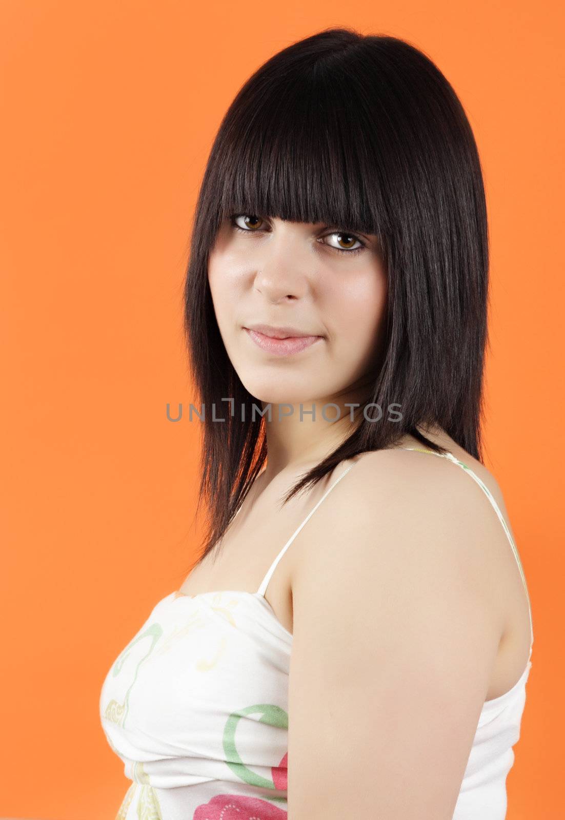 portrait of pretty teen girl, orange background