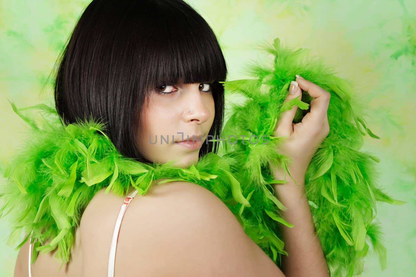 portrait of pretty teen girl with green feather boa