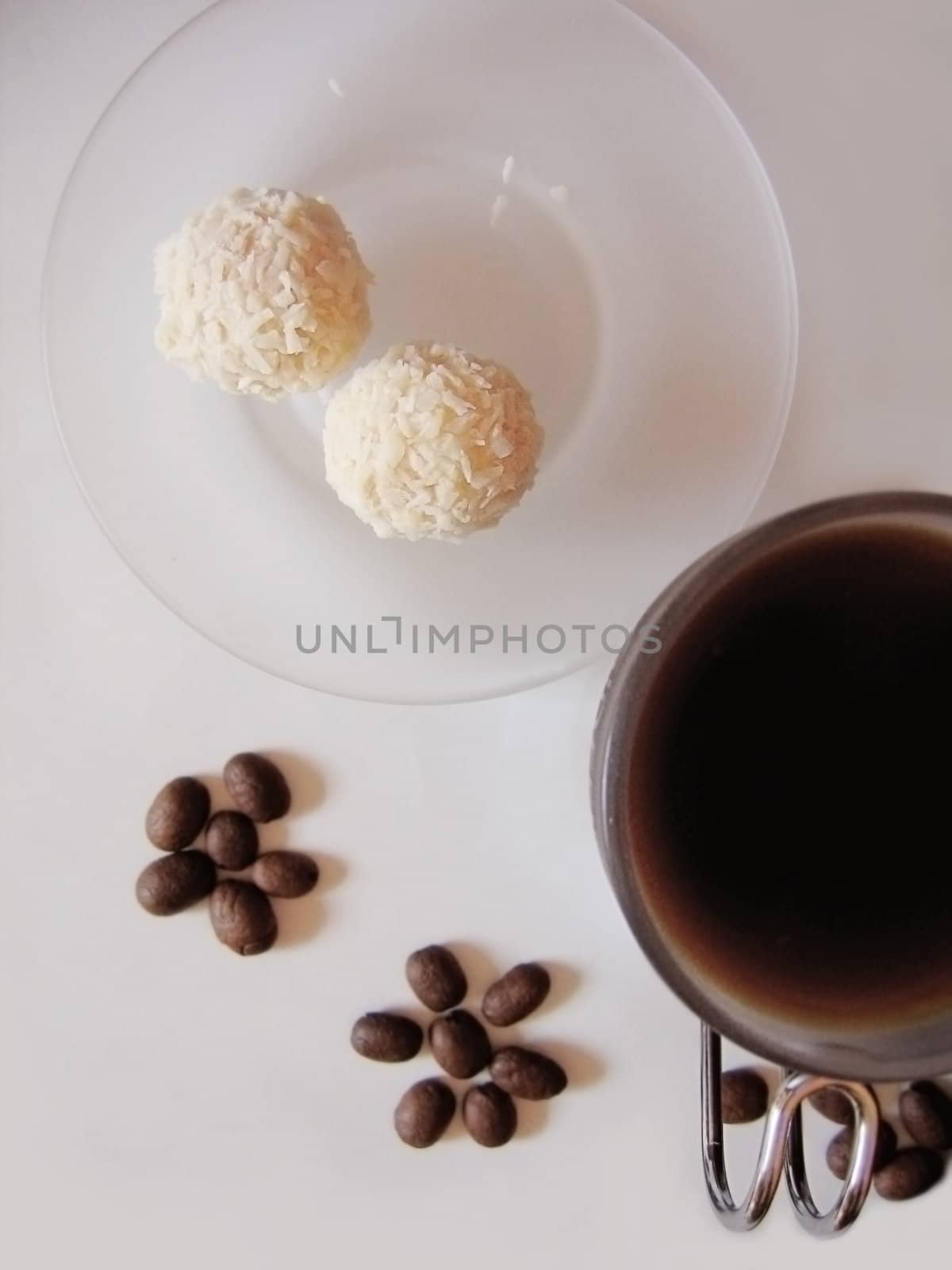 cup of coffee with coconut sweets and benas