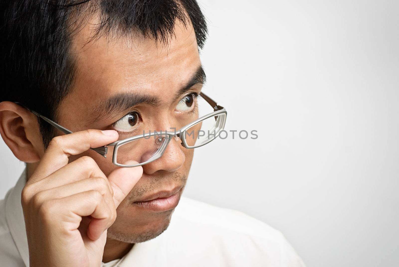 Asian businessman watch and put hand on glass.