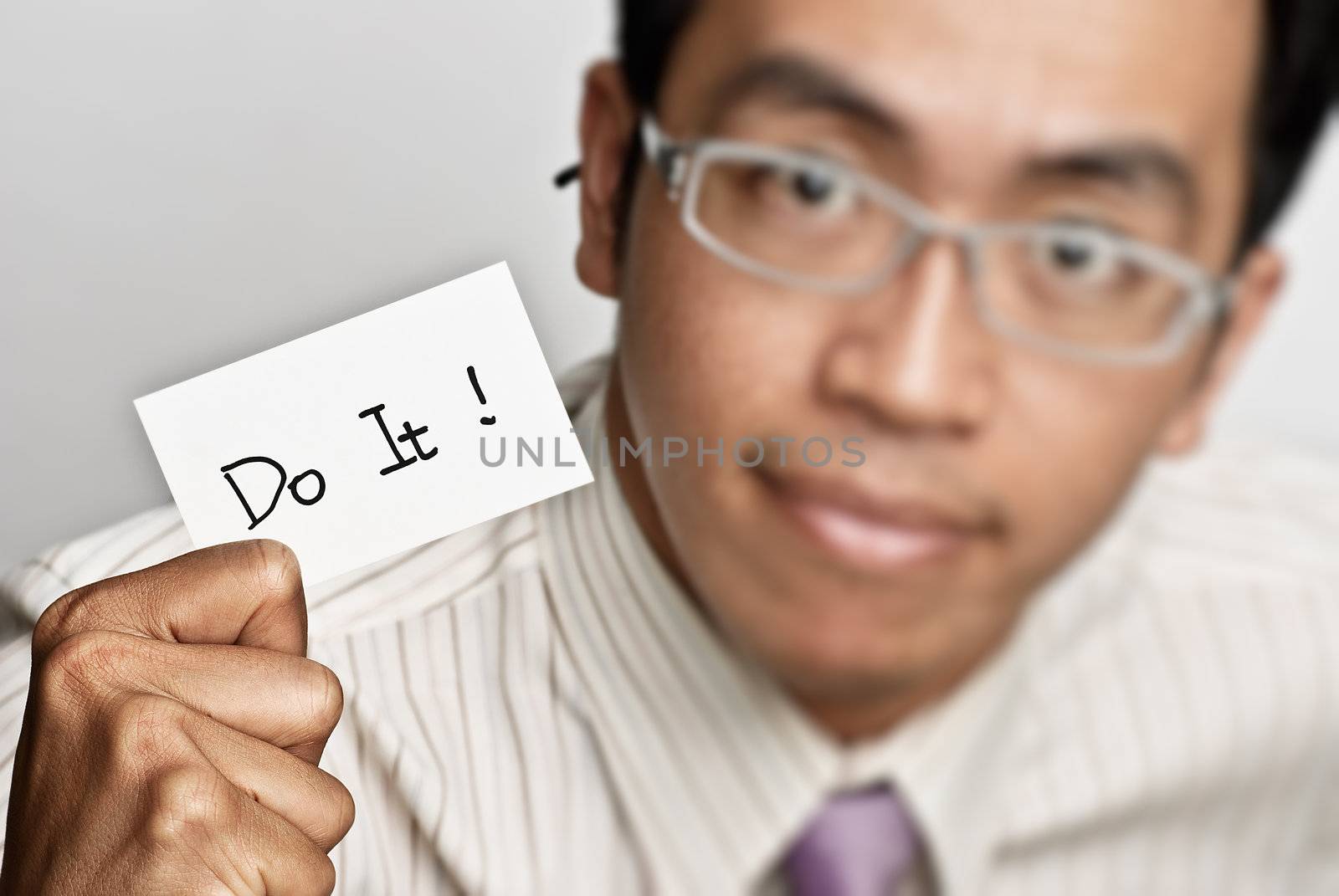 Positive businessman holding white card - do it.