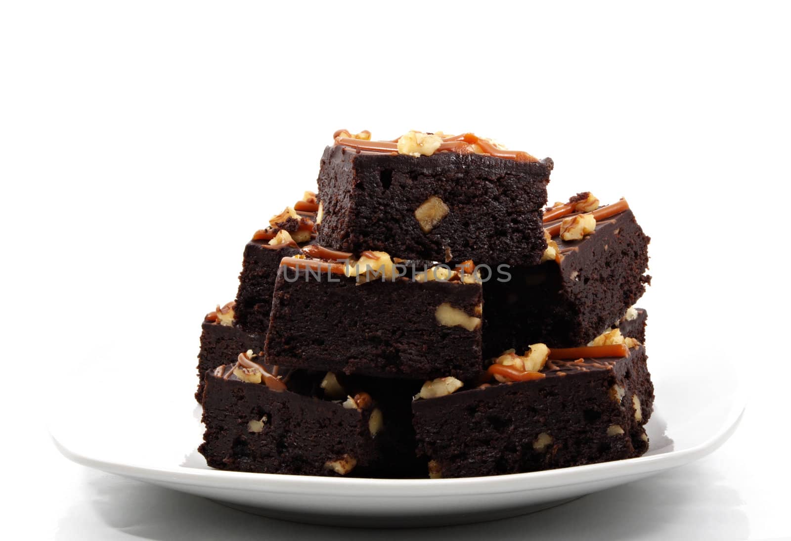 brownies with nuts on white plate