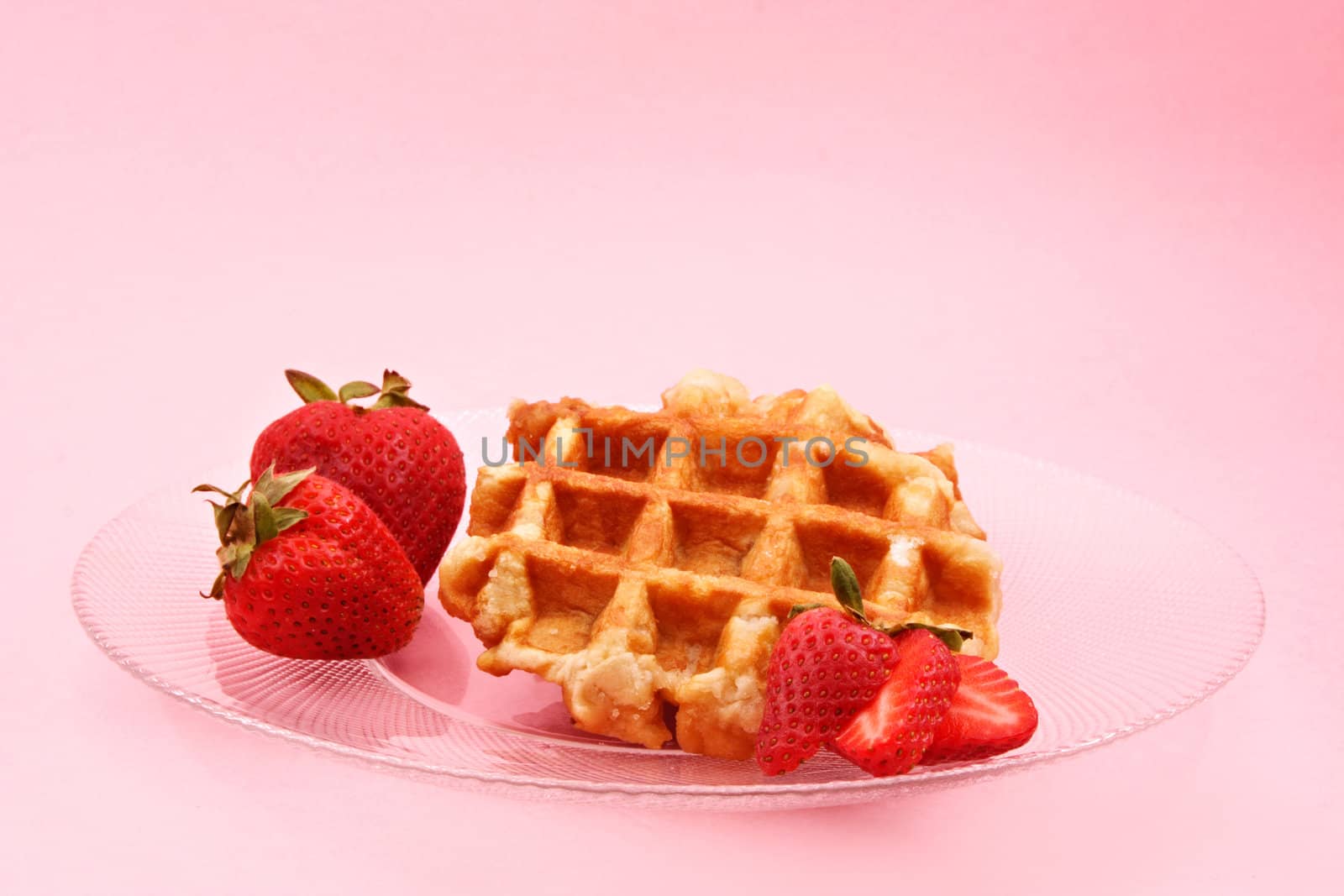 belgian waffle and fresh strawberries, pink background