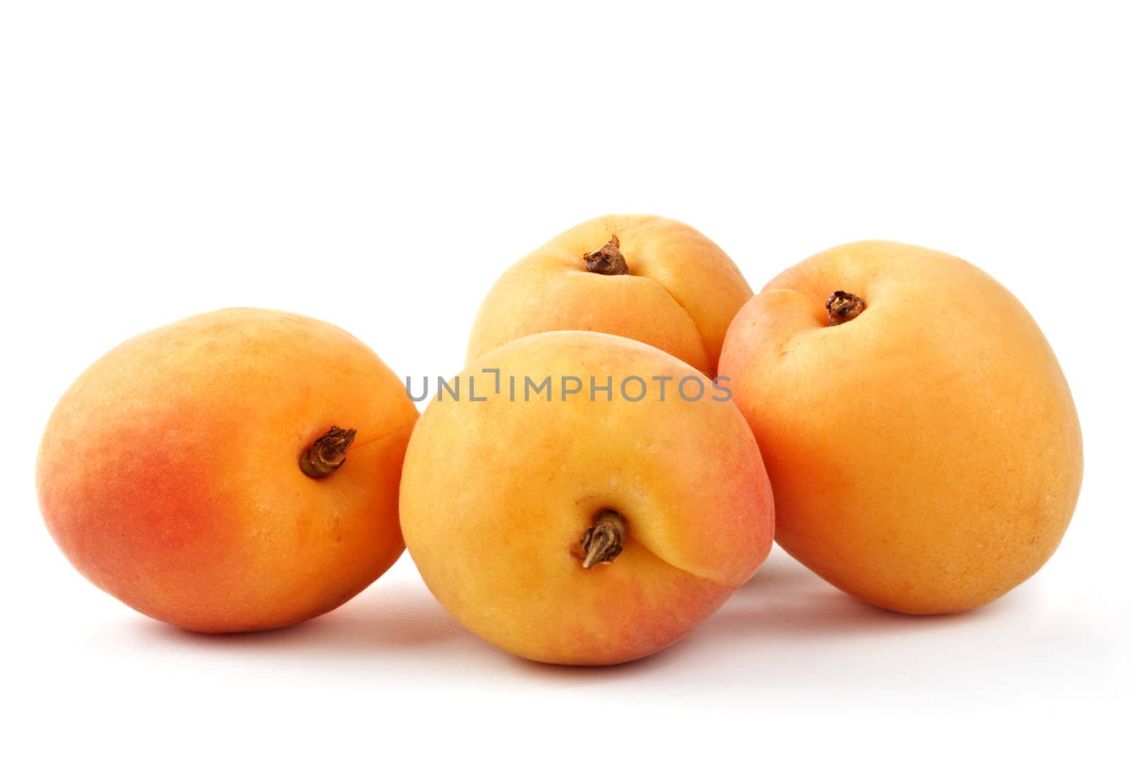 four fresh apricot fruit isolated on white