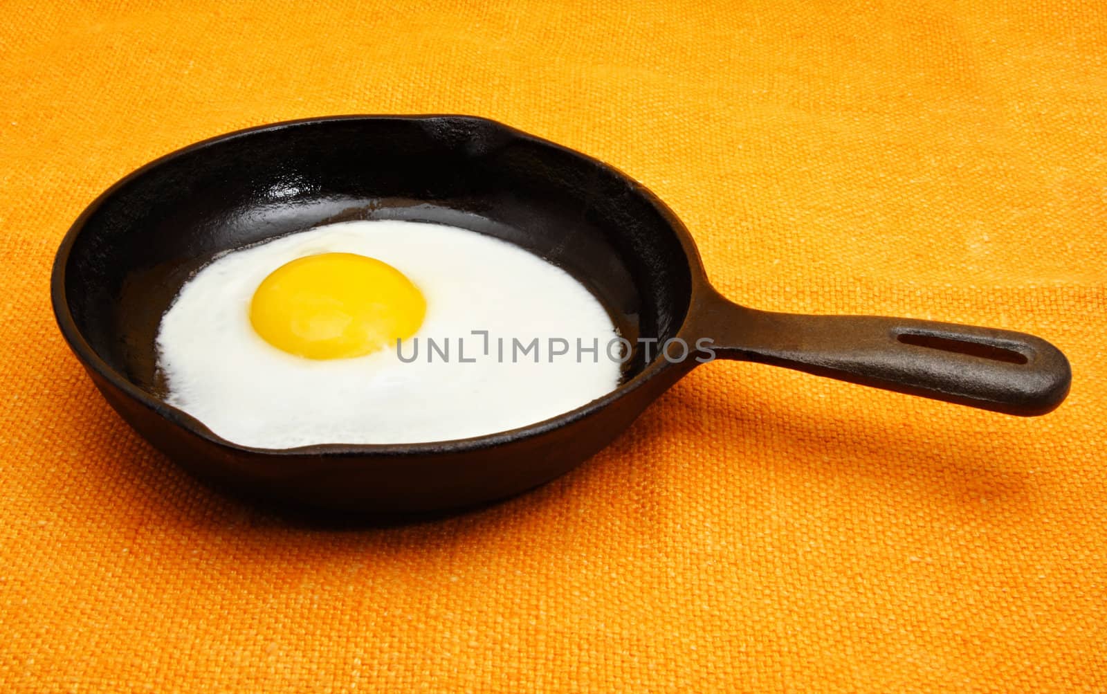 sunny side-up egg on a black cast iron pan