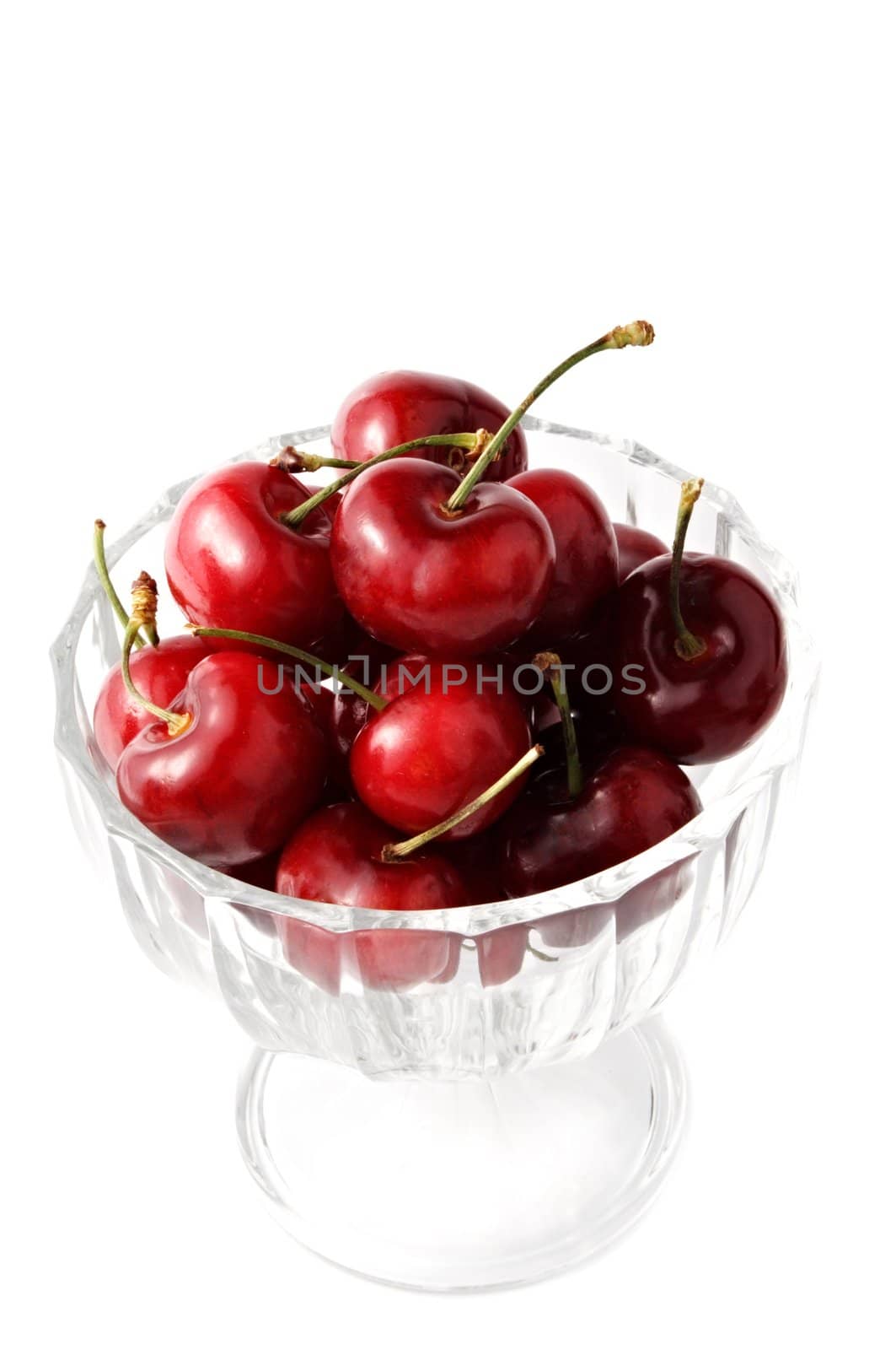 cherries in a glass bowl, isolated on white