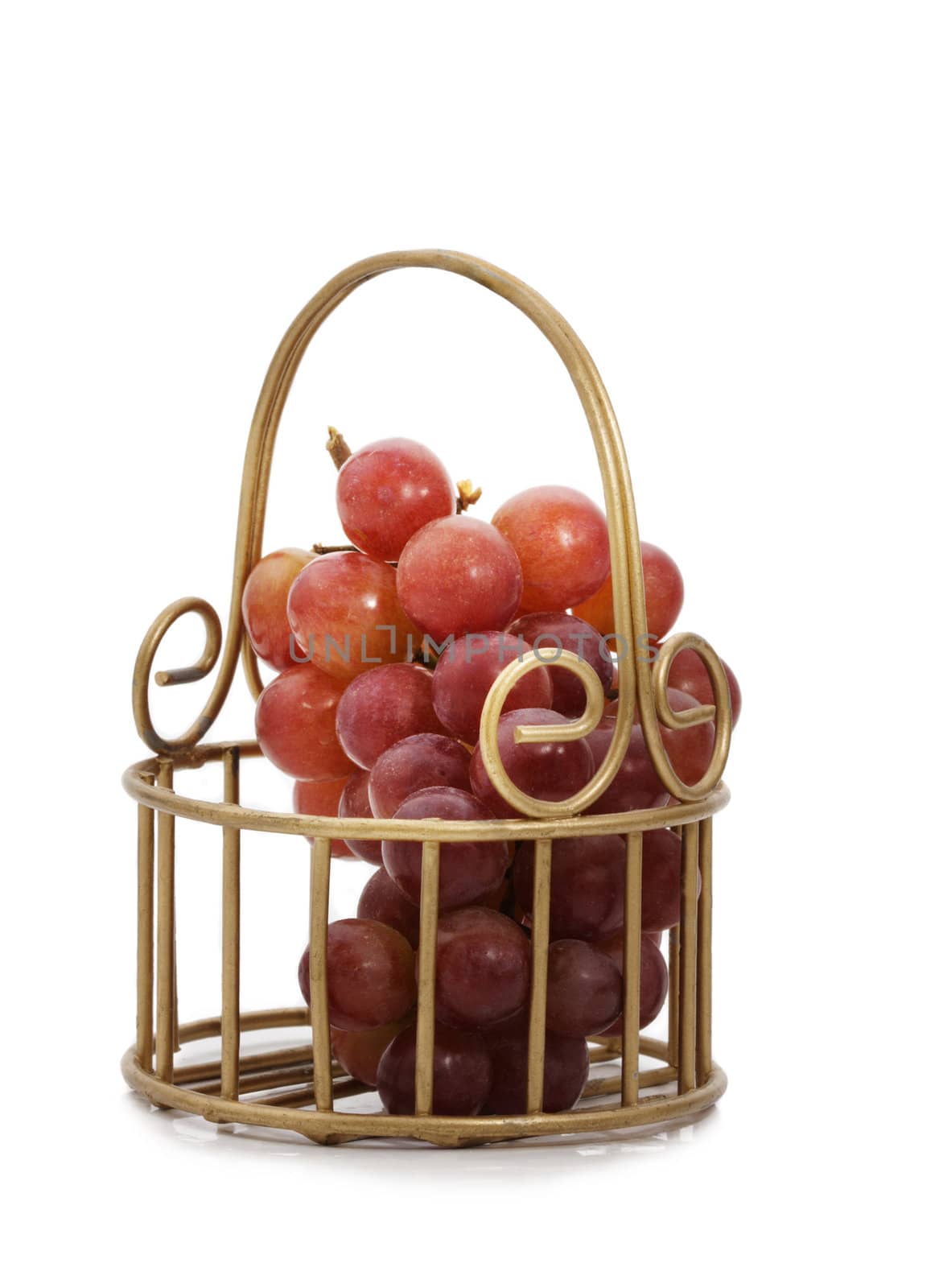 red grape in golden metal basket, white background